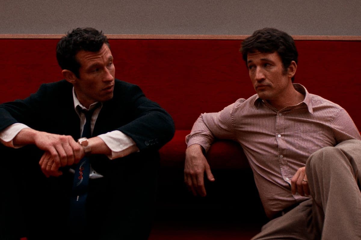 Actors Callum Turner and Miles Teller sit next to each other in conversation in a still from Eternity. 