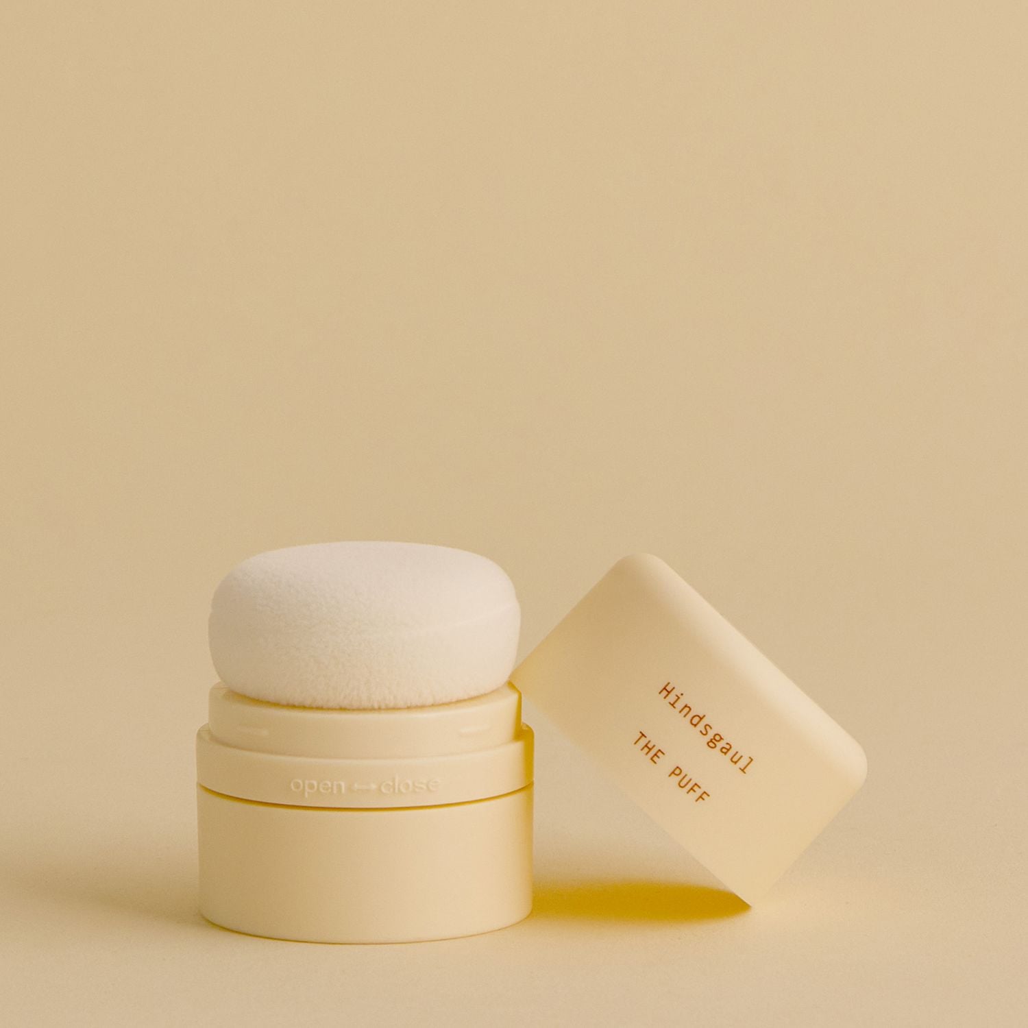 A bottle of the Hindsgaul Hair Dry Shampoo against a pale yellow background 