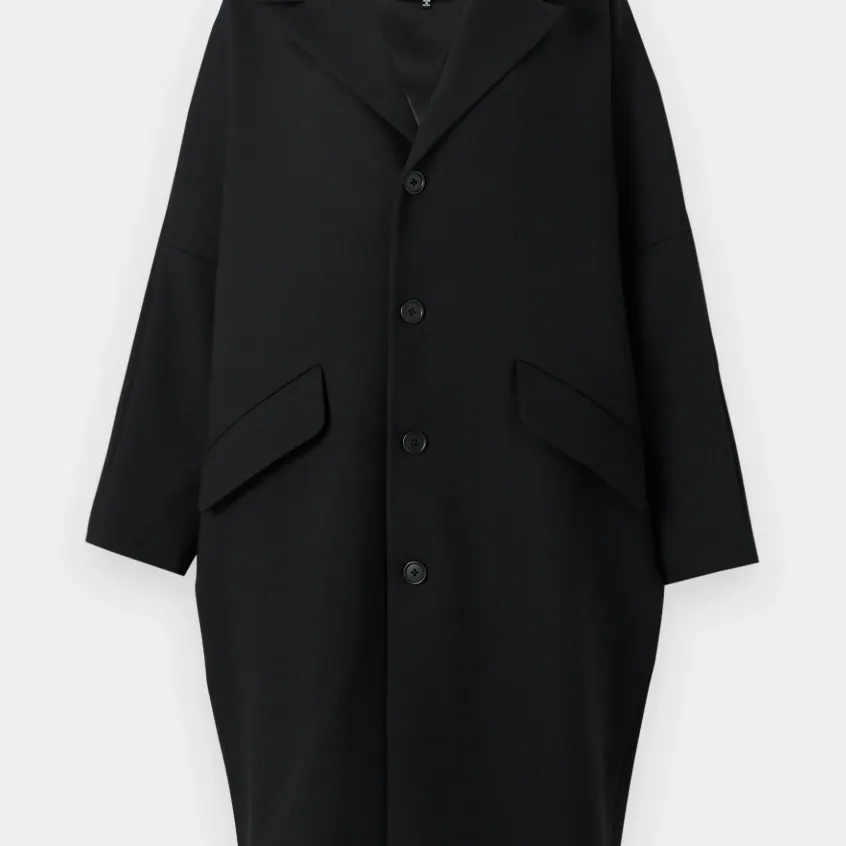 A cocoon-shaped black wool coat from MM6 Maison Margiela against a white background. 