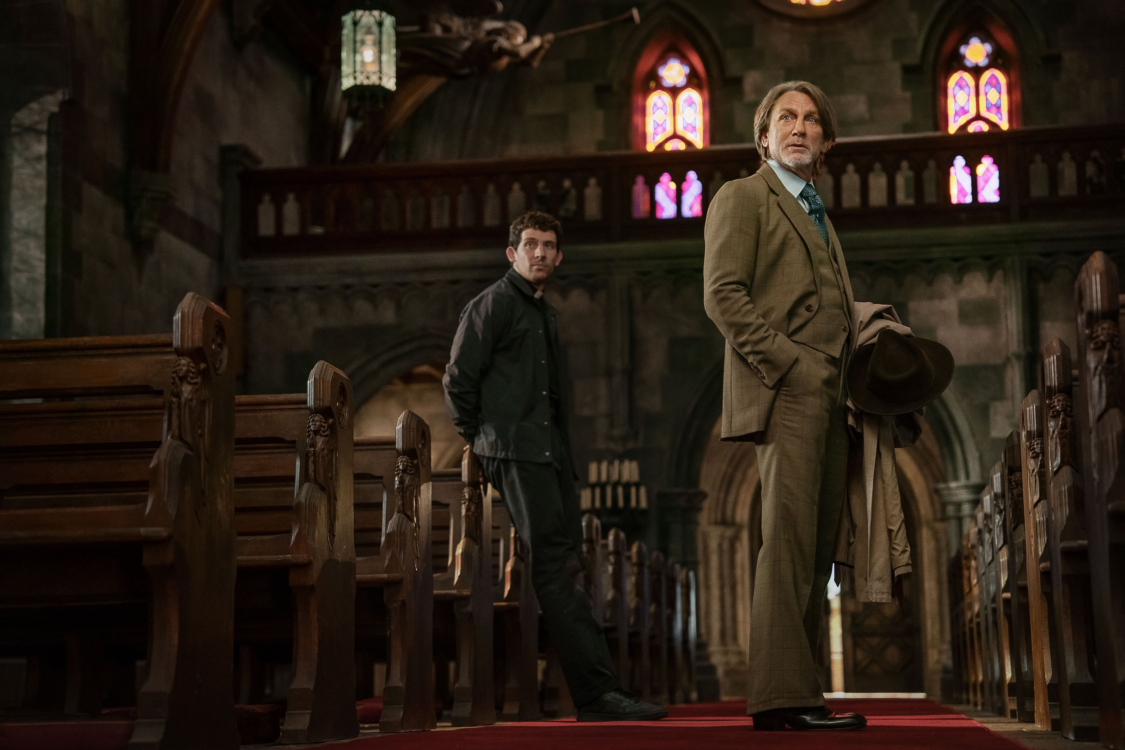 Actor Daniel Craig stands in a church in a still from Wake Up Dead Man: A Knives Out Mystery.