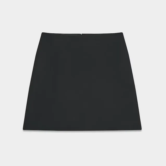 Black mini skirt against a light gray background
