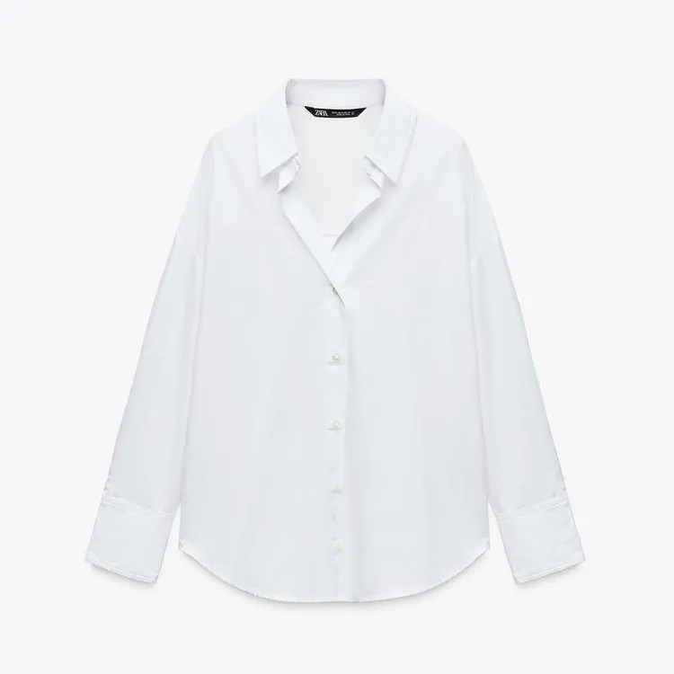 white button down shirt against an off-white background 