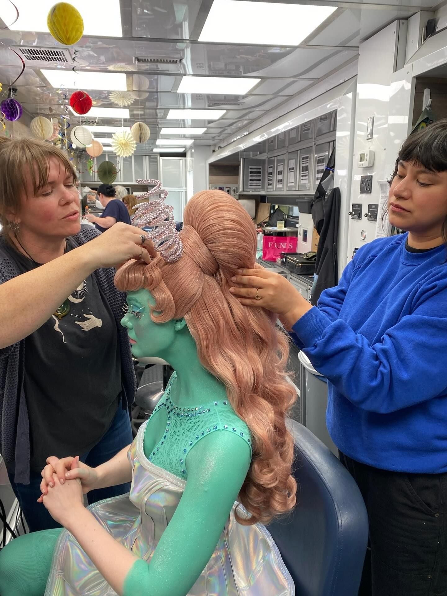 Jaime Leigh McIntosh (left) attaching the wig to Elle Fanning for the 'fantasy' scene.