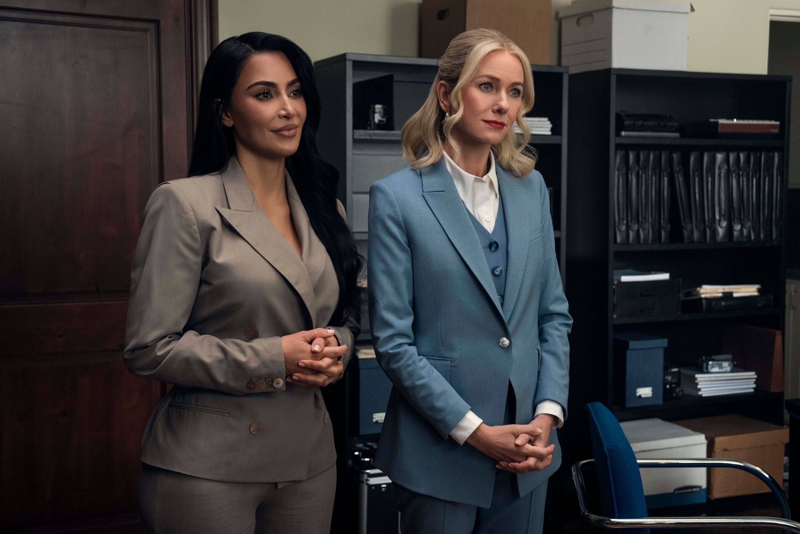 Kim Kardashian and Naomi Watts stand in an office in a still from Hulu's All's Fair.
