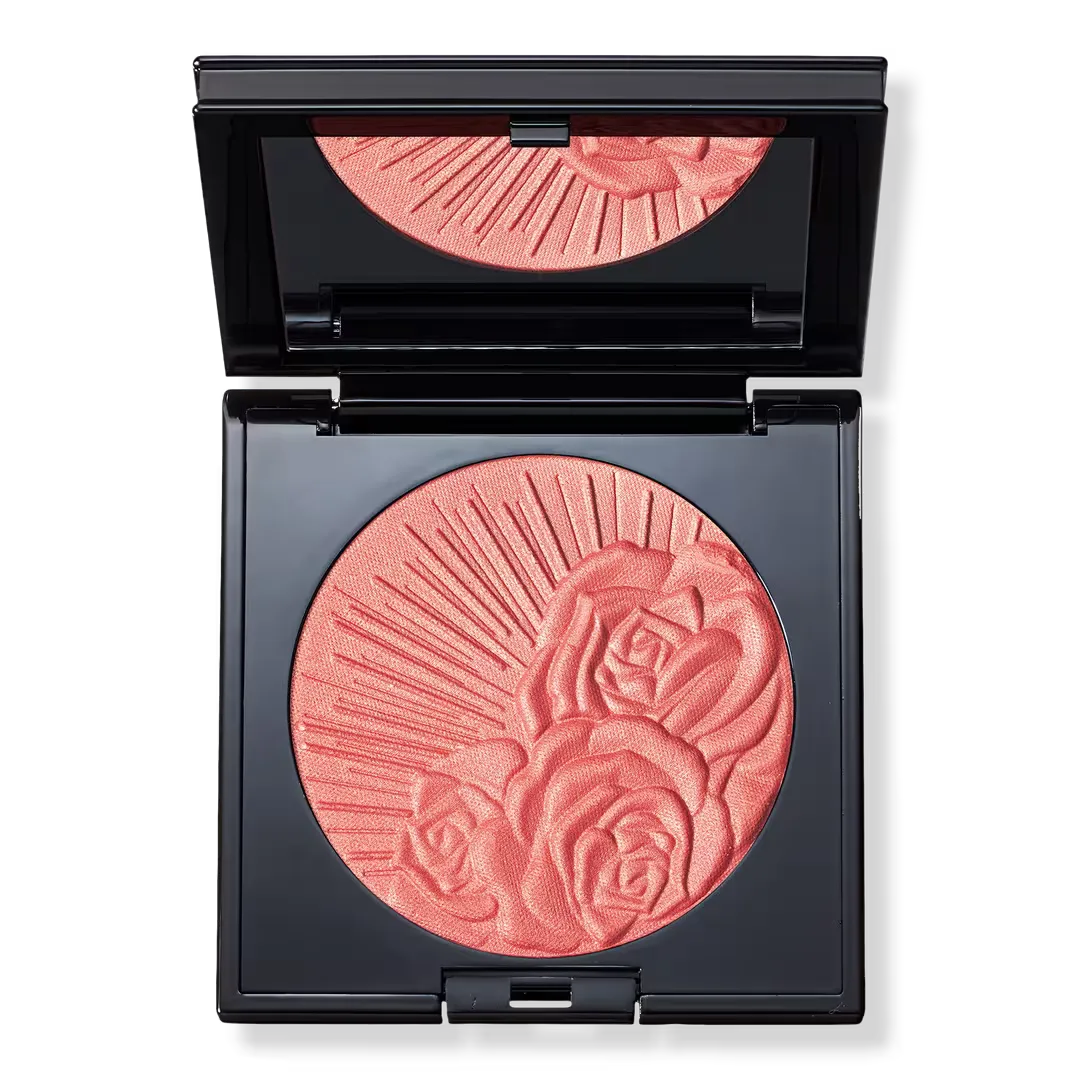 An open blush compact, the powder embossed with roses