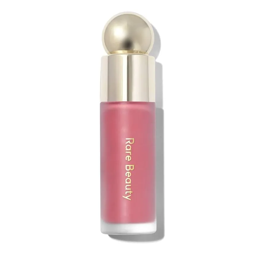 A tube of pink liquid blush from Rare Beauty with a silver cap