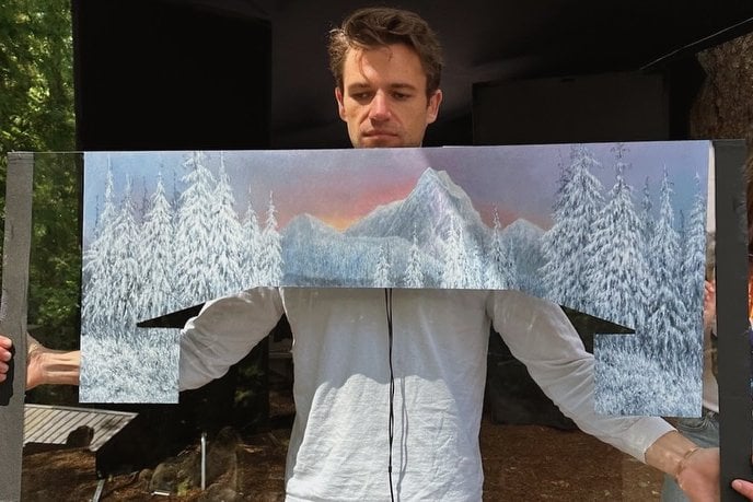 Co-producer Willy McGee holding up one of the hand-painted glass panels used in "Teenage Sex and Death At Camp Miasma".