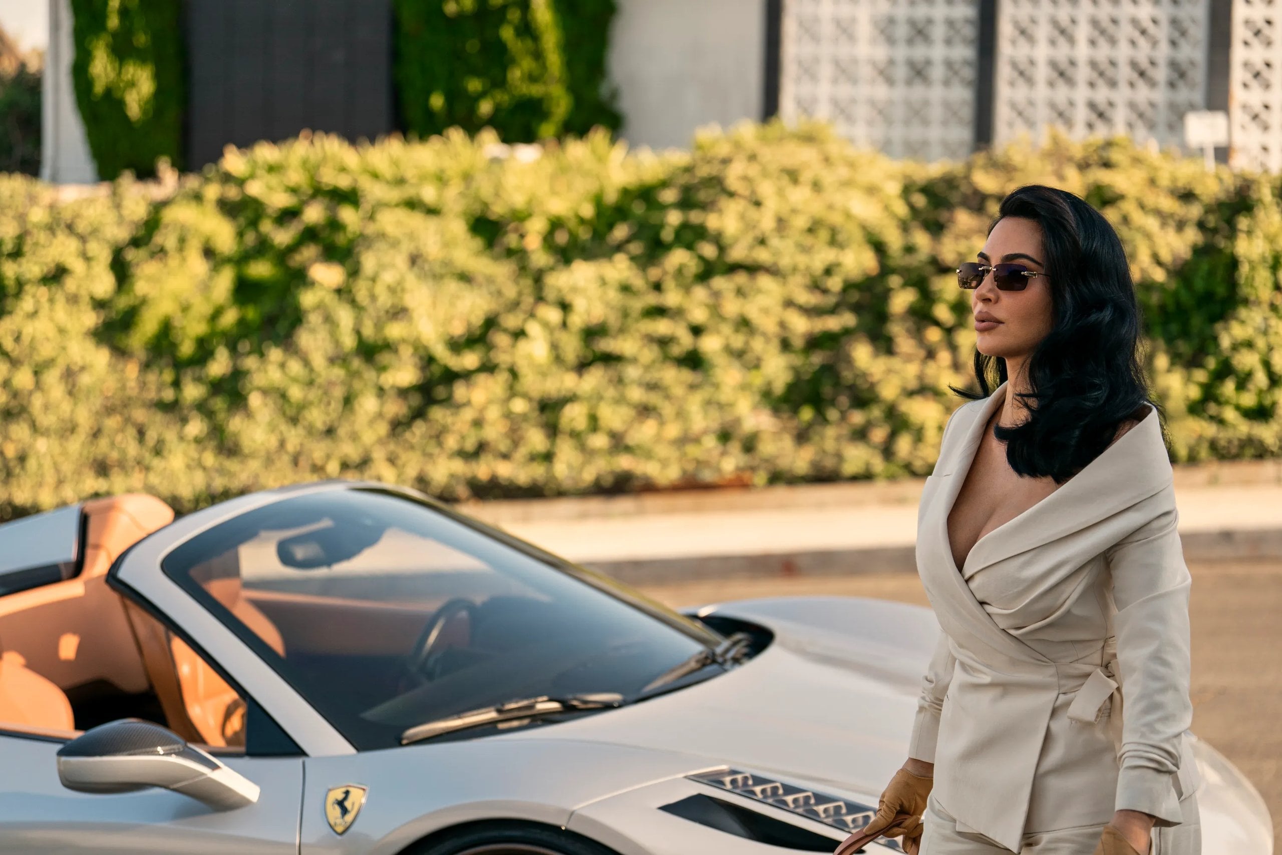 Ki Kardashian exits a fancy silver car in a still from Hulu's All's Fair.