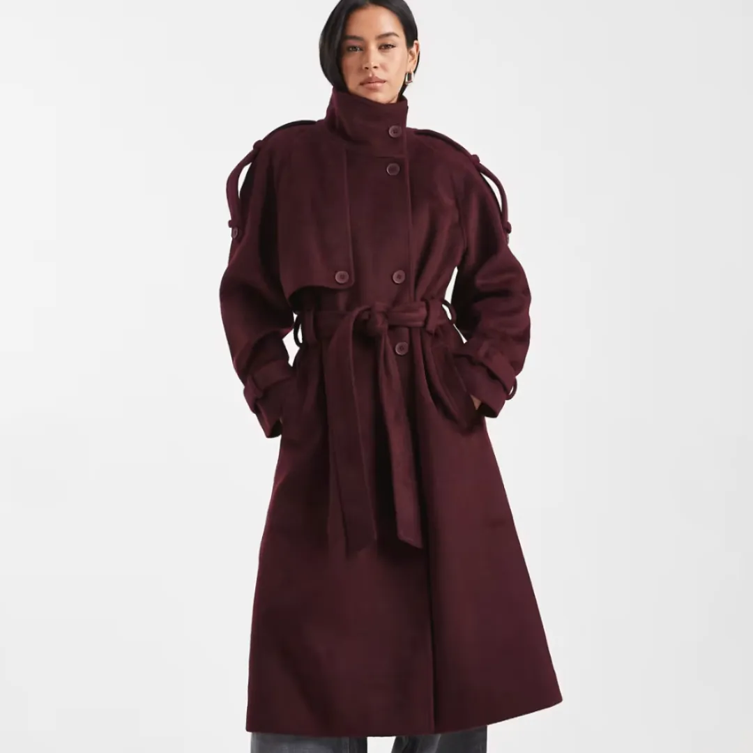 A model wears the ASOS Design formal longline funnel neck trench coat in burgundy