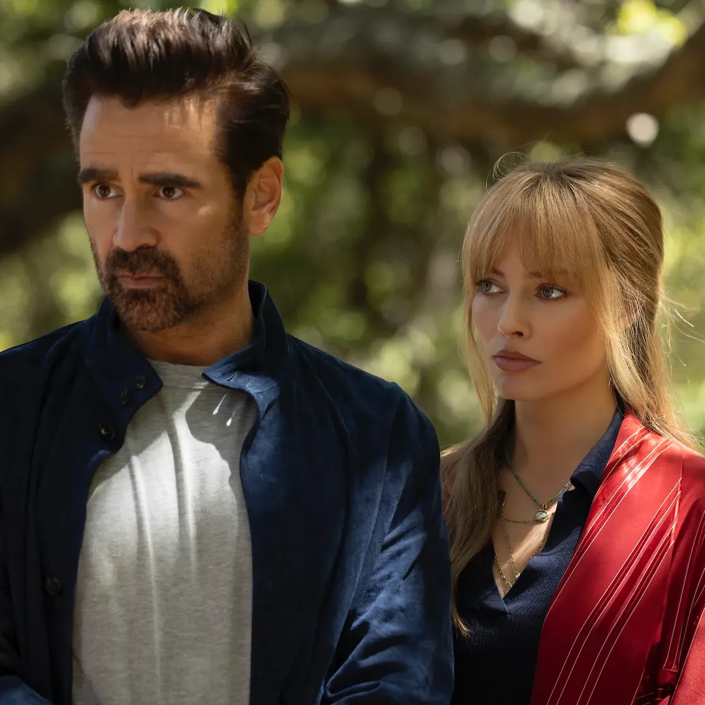 Actors Colin Farrell and Margot Robbie stand shoulder to shoulder outside in a still from "A Big Bold Beautiful Journey".