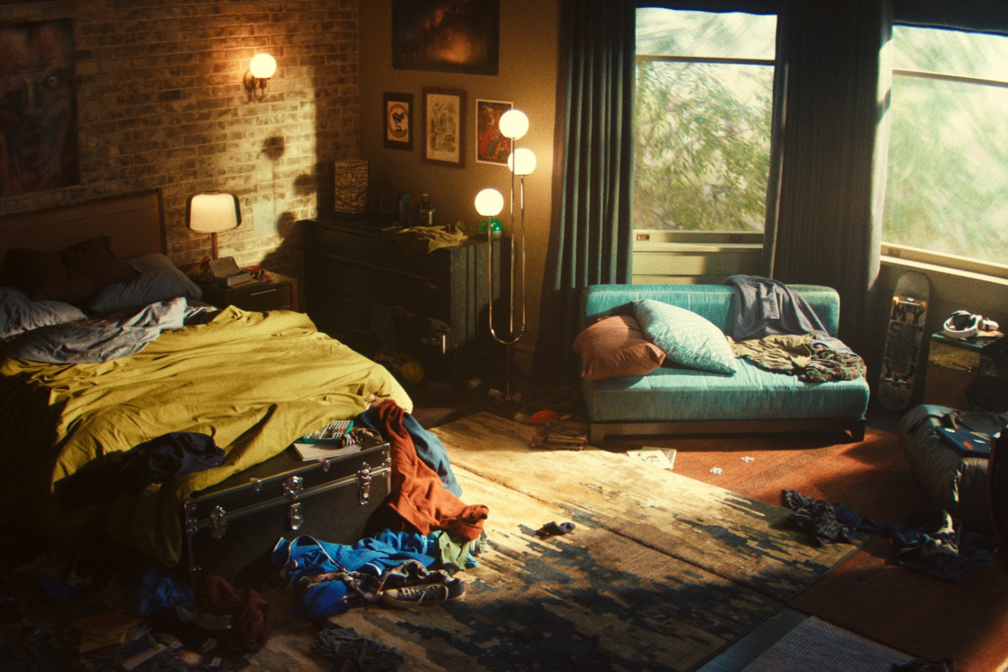 Zack's room is adorned with posters and art on exposed brick.