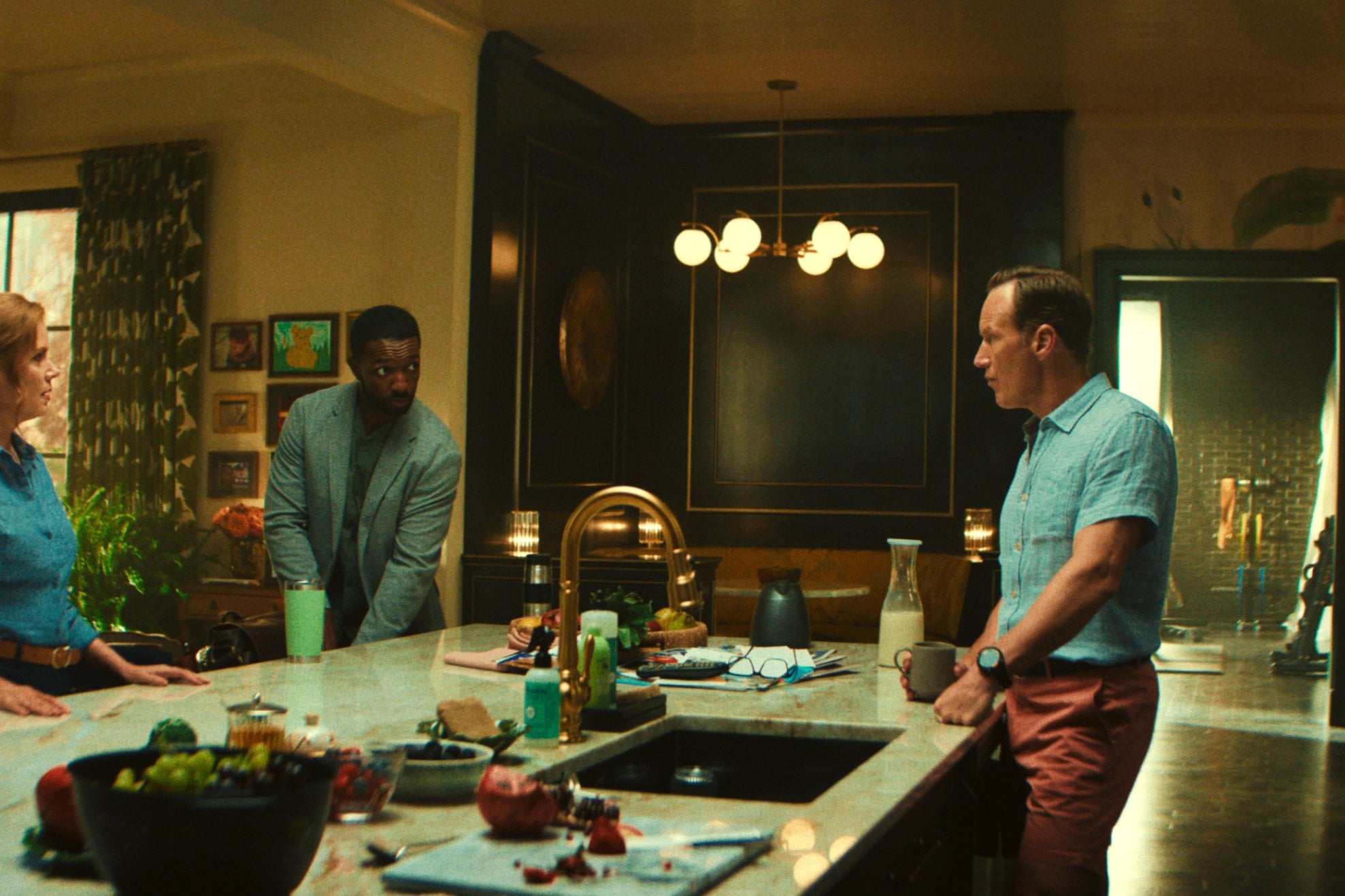 A tropical-themed wallpaper can be seen in the kitchen.