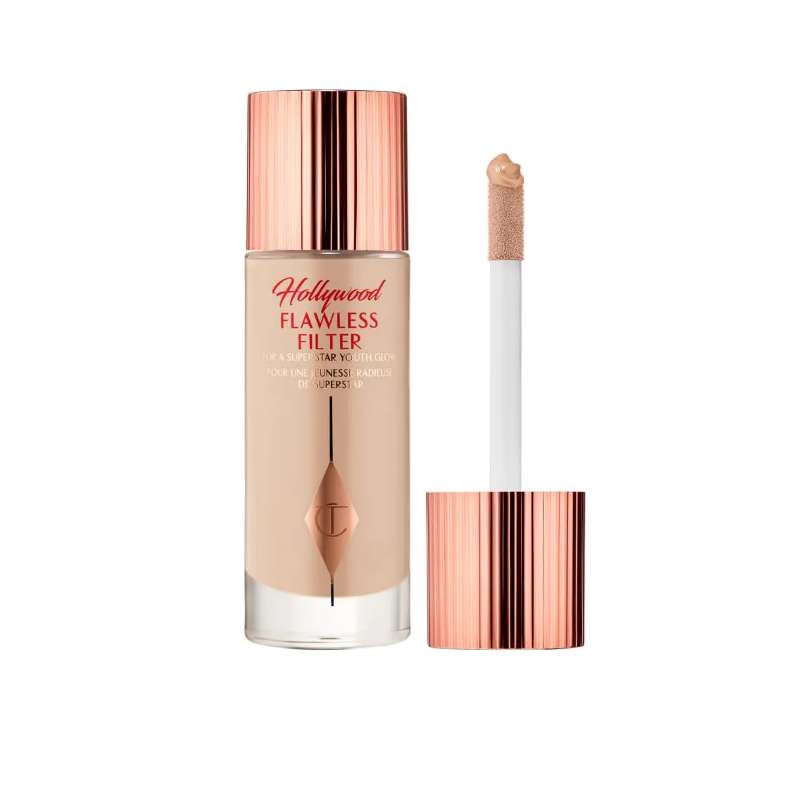A bottleof Charlotte Tilbury flawless filter, a shimmering beige fluid in a glass bottle, on a white background