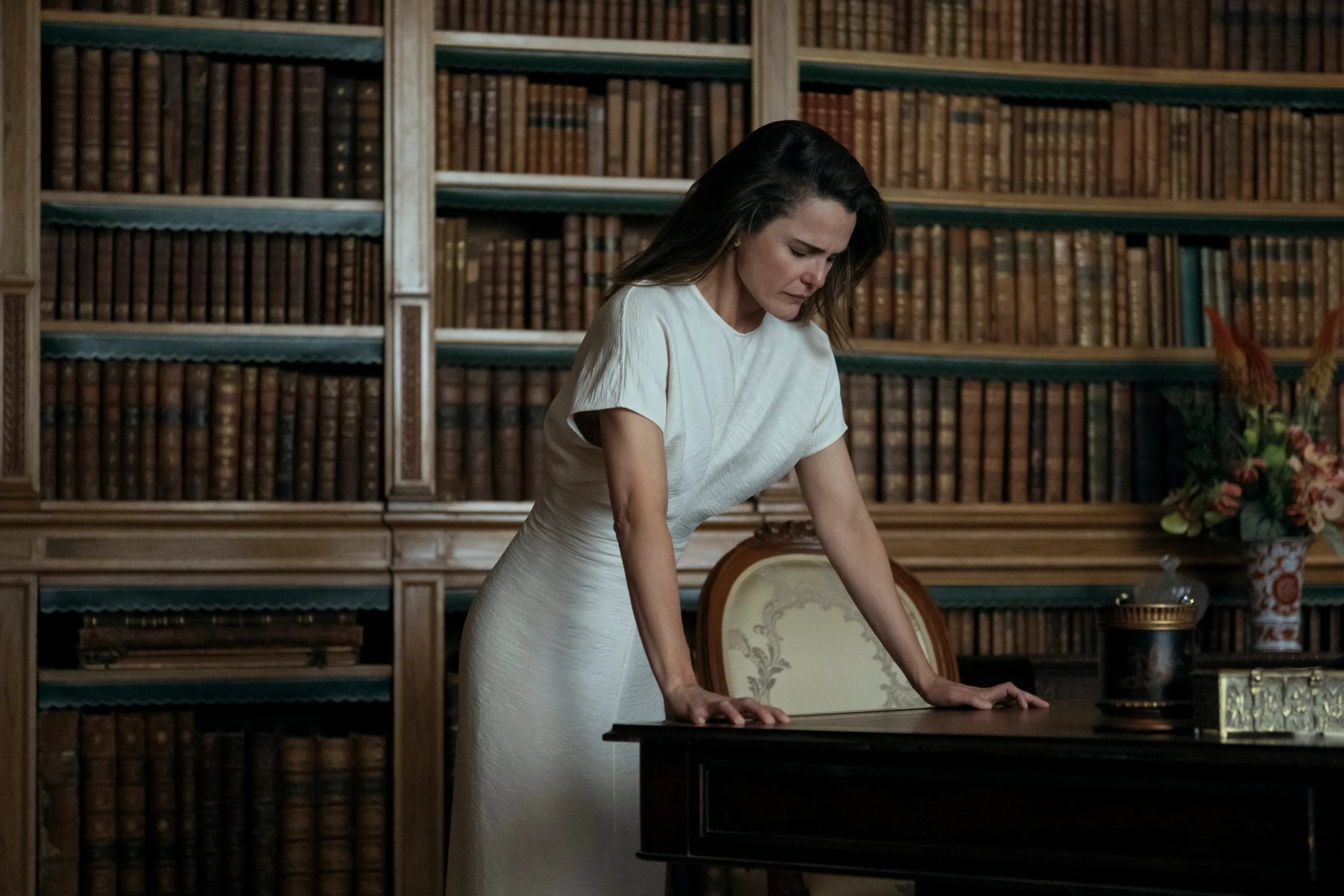 Keri Russell stands over a table looking stressed in a still from The Diplomat.