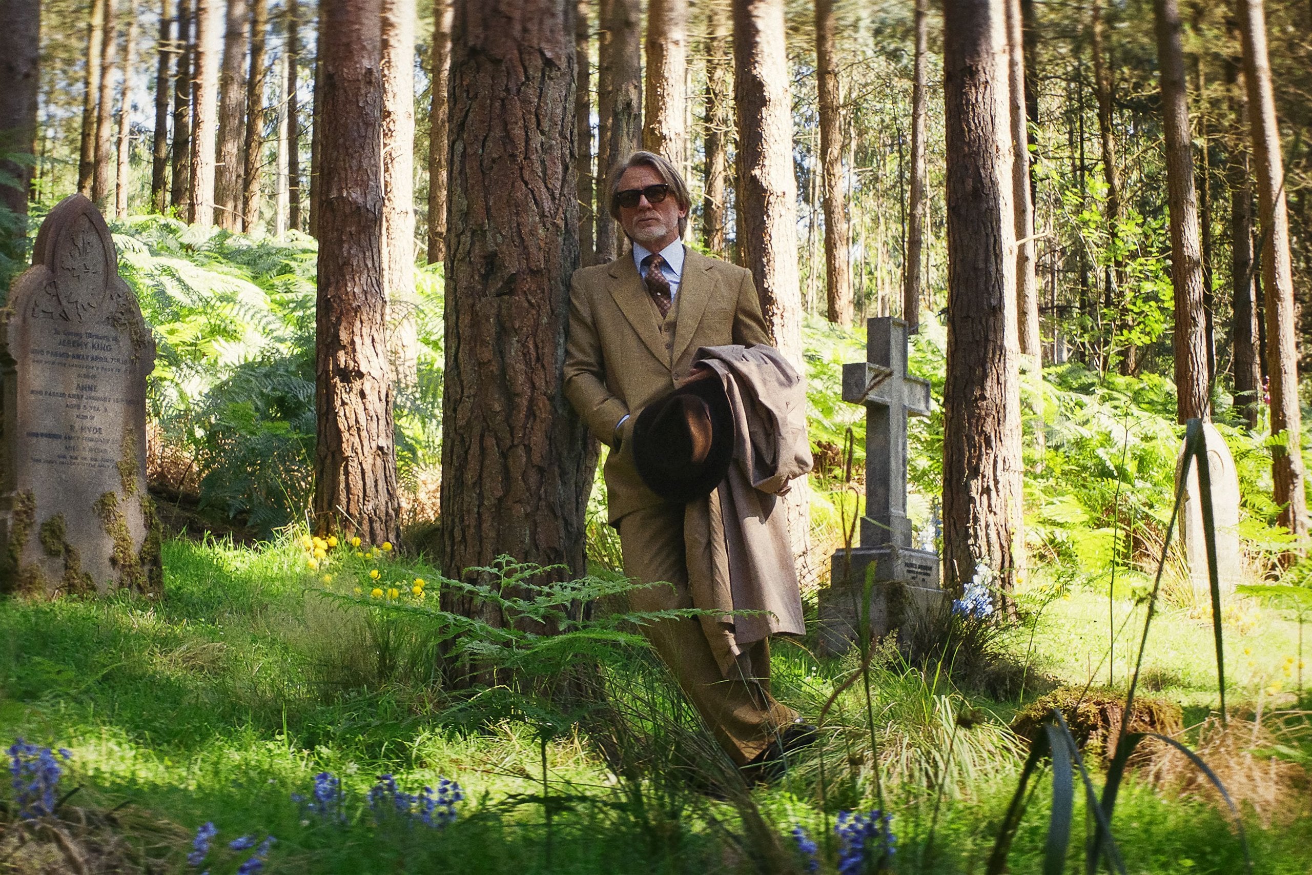 Actor Daniel Craig stands suited in a graveyard in "Wake Up Dead Man: A Knives Out Mystery."