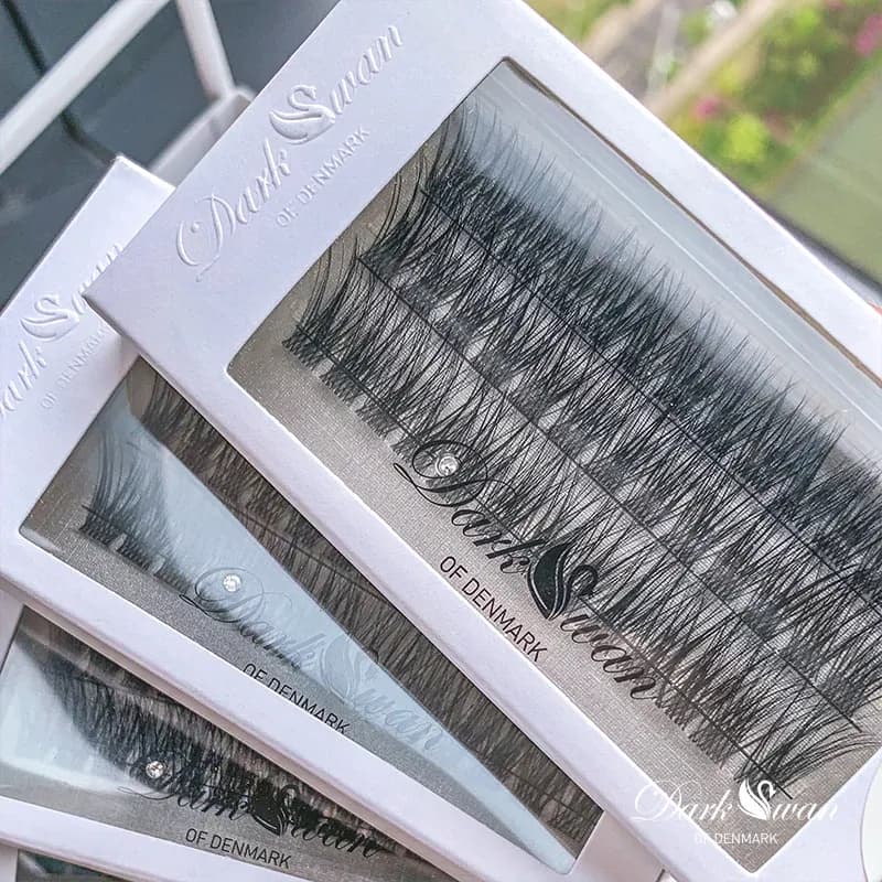 Three boxes of individual false lashes stacked on top of one another