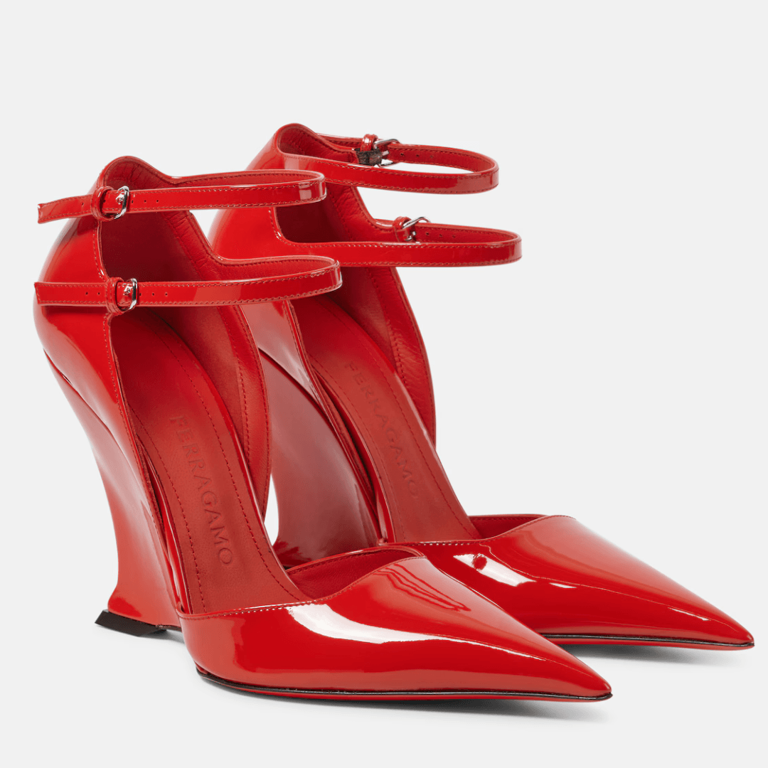 Shiny red Ferragamo Vidya X5 patent leather wedge pumps against an off-white background