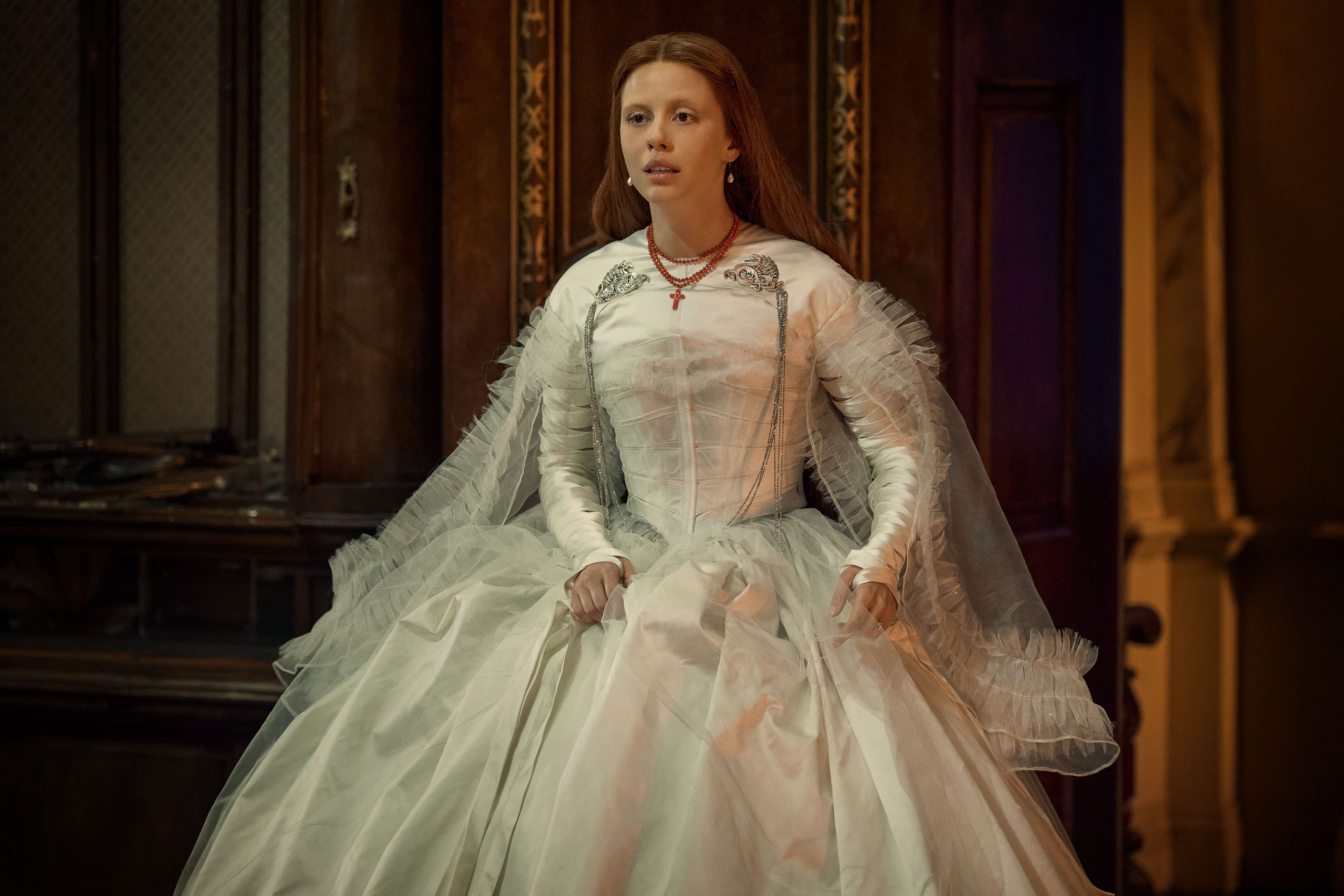 Mia Goth, in a white Victorian-era wedding dress, in a still from Frankenstein.