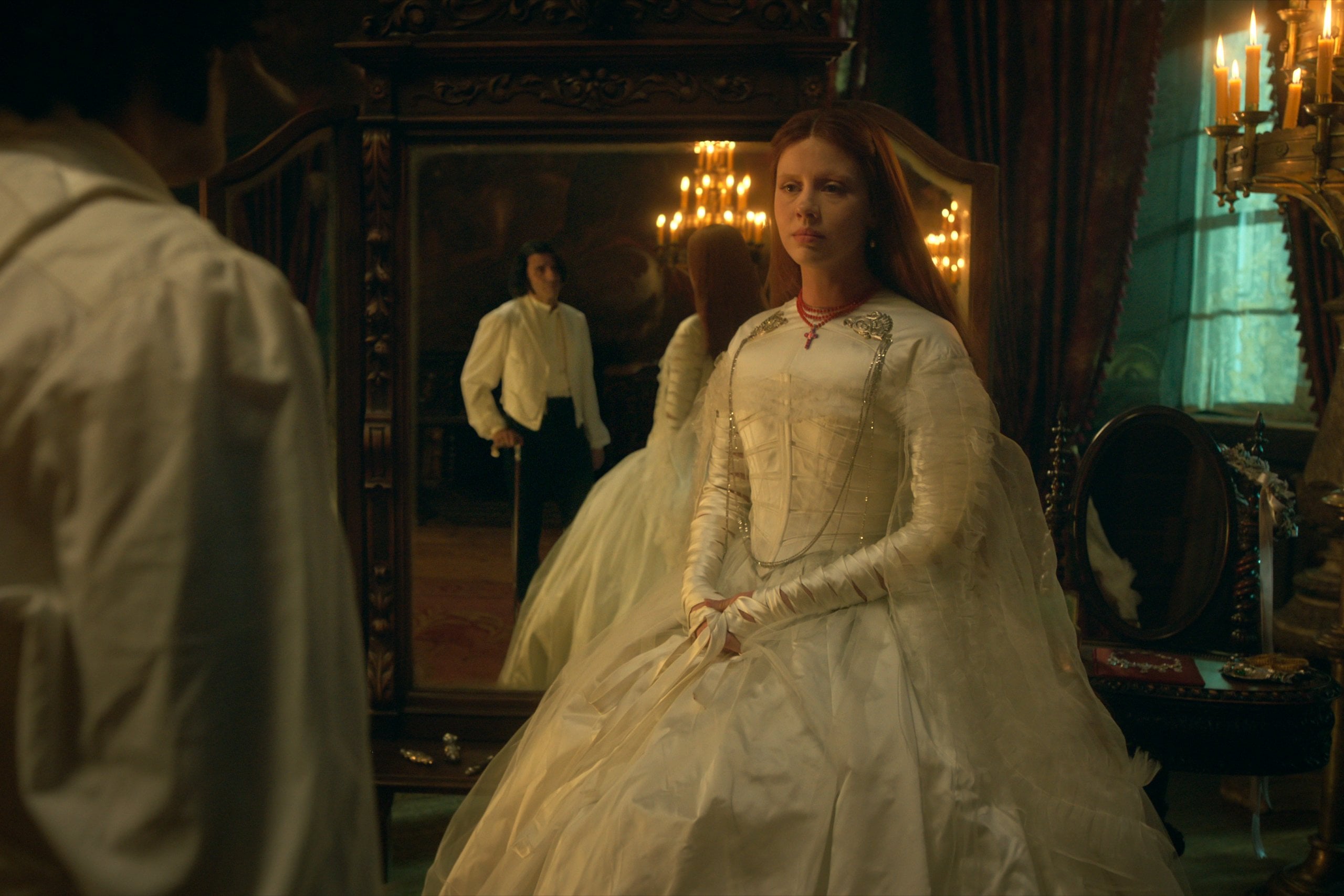 Mia Goth, in a white Victorian-era wedding dress, in a still from Frankenstein.
