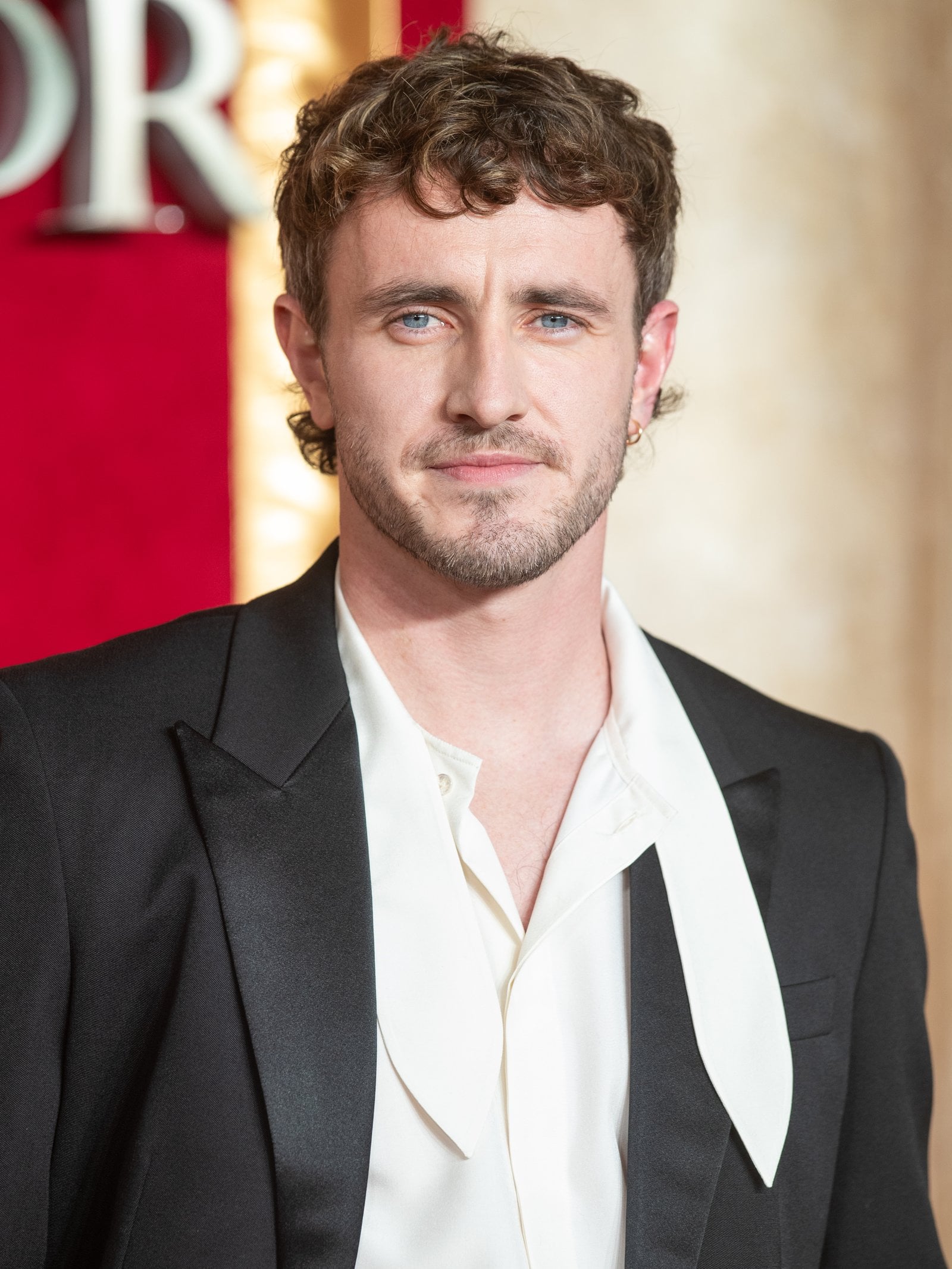 Paul Mescal attends "Gladiator II" The Royal Film Performance in 2024 wearing a black suit with a white shirt.