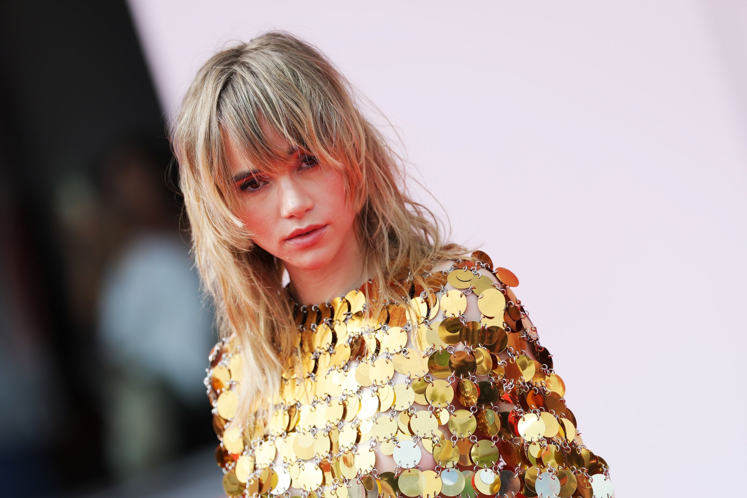 Suki Waterhouse attends the "Broken English" red carpet in a gold dress.