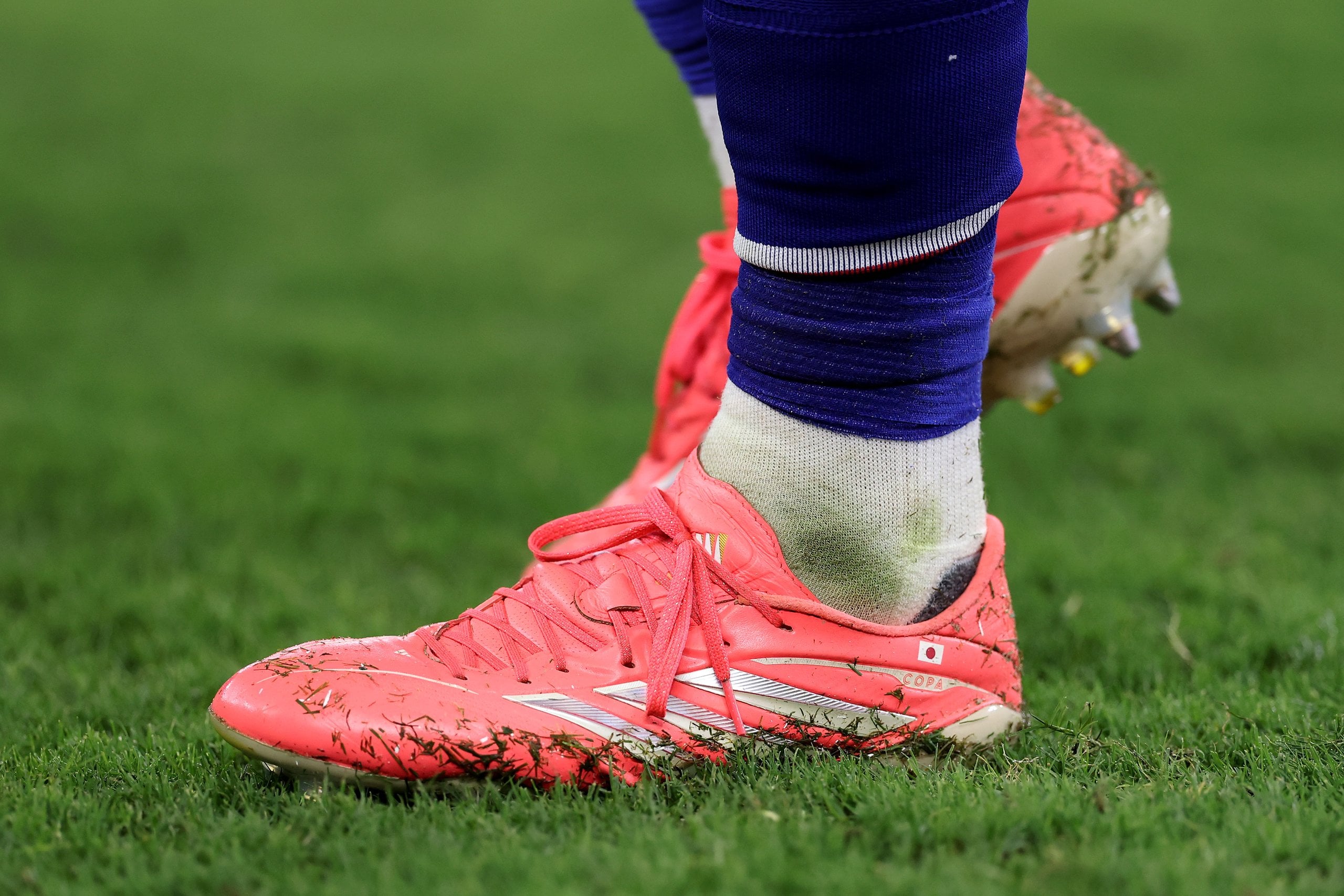 A detailed view of the Pink adidas cleats of Hiroki Ito #21 of Japan during the FIFA World Cup 2026.