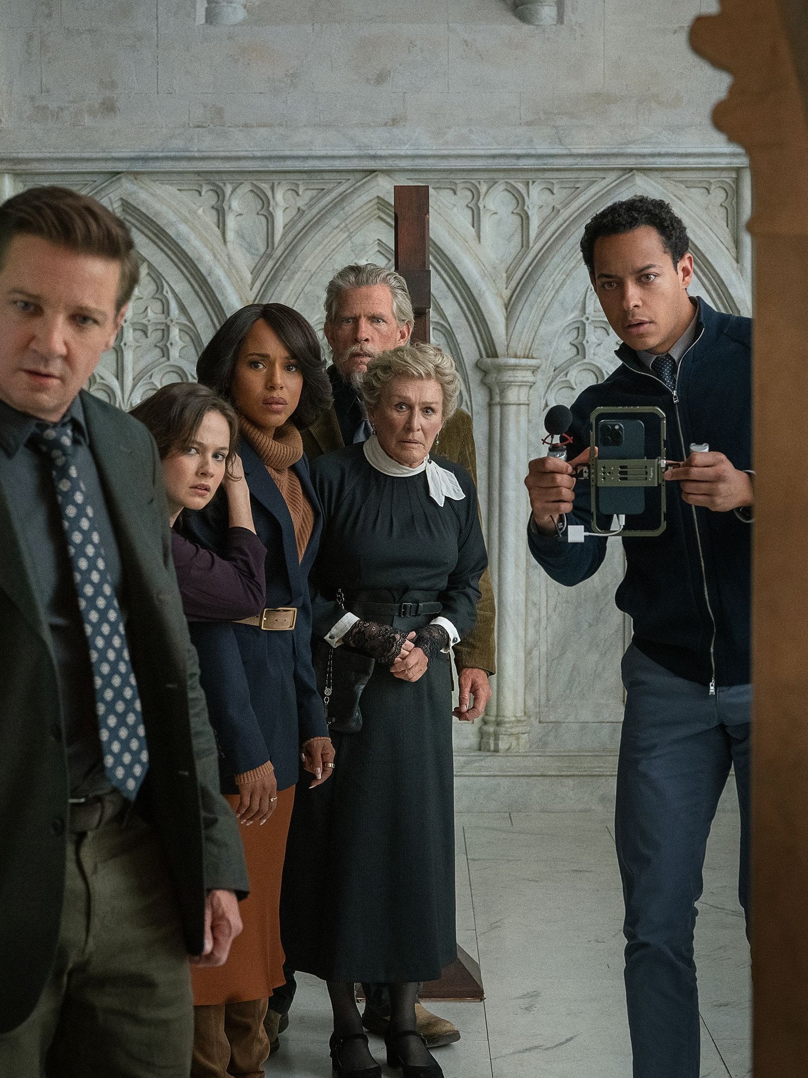 A group shot of "Wake Up Dead Man: A Knives Out Mystery" cast members in a church. Photo: John Wilson / Netflix.