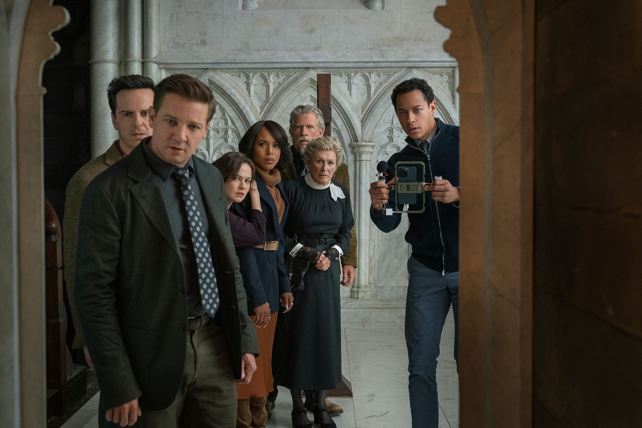 A group shot of "Wake Up Dead Man: A Knives Out Mystery" cast members in a church. Photo: John Wilson / Netflix.