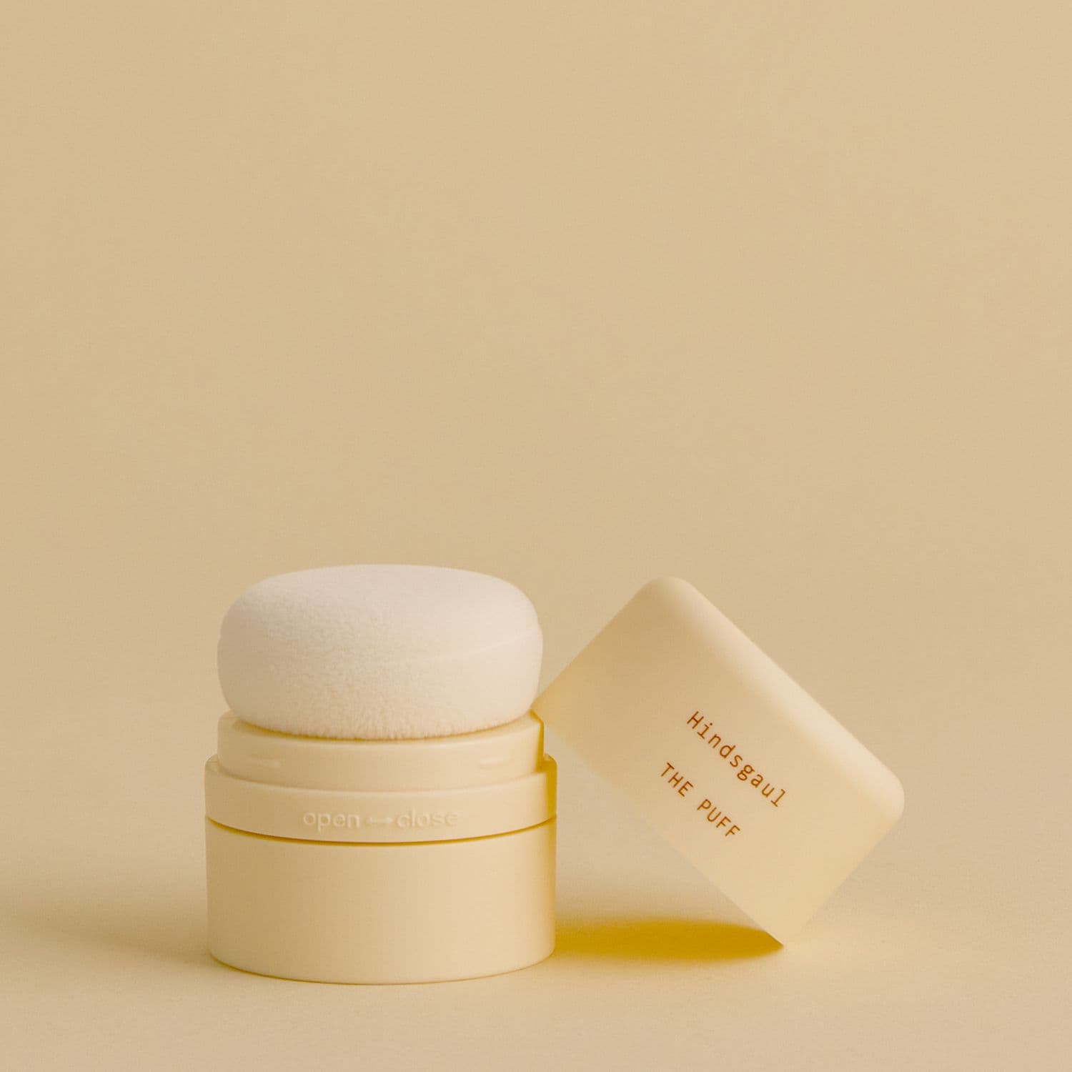A bottle of the Hindsgaul Hair Dry Shampoo against a pale yellow background