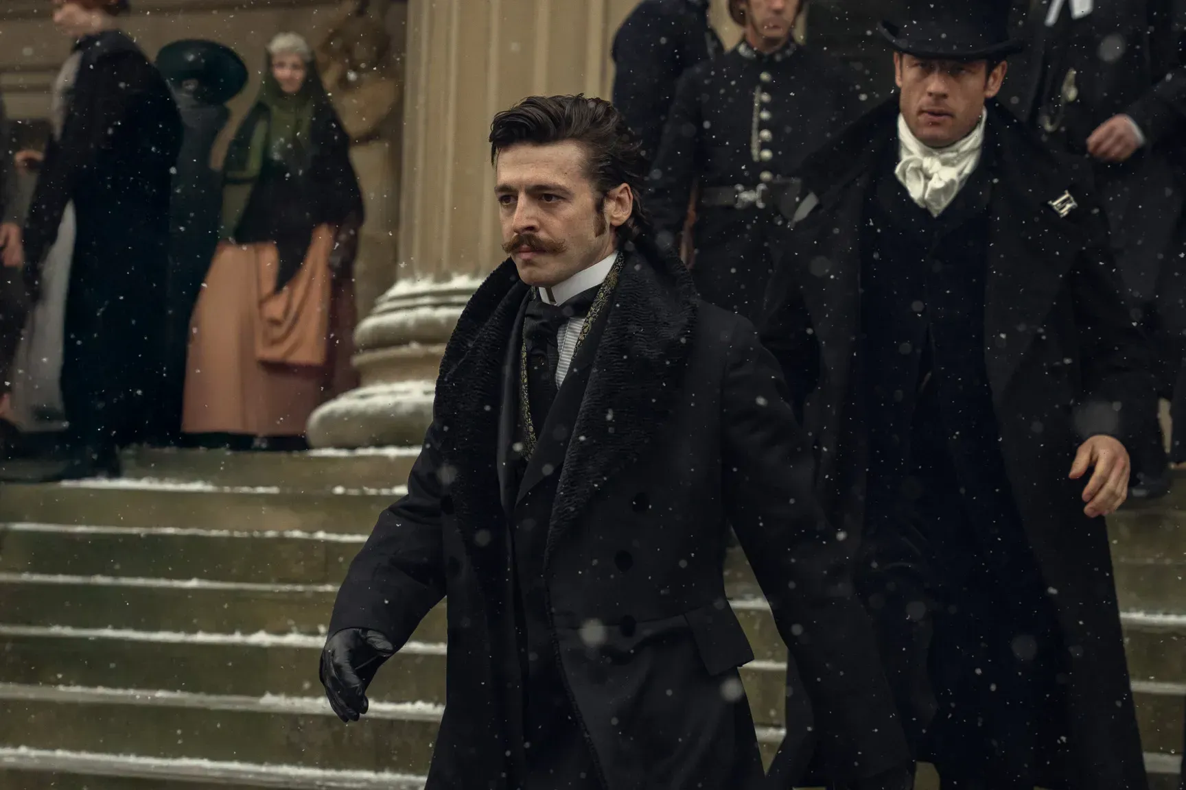 Anthony Boyle walks down the stairs of a government building in a still from the "House of Guinness."