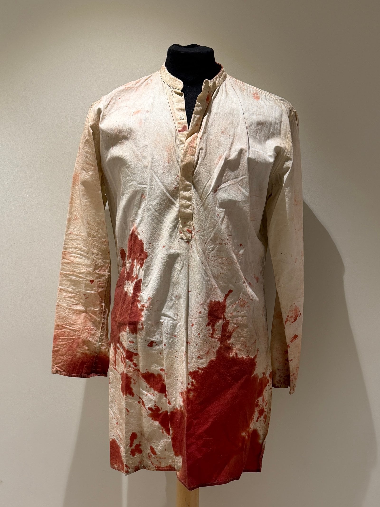 Bloodstains begin to cover it.