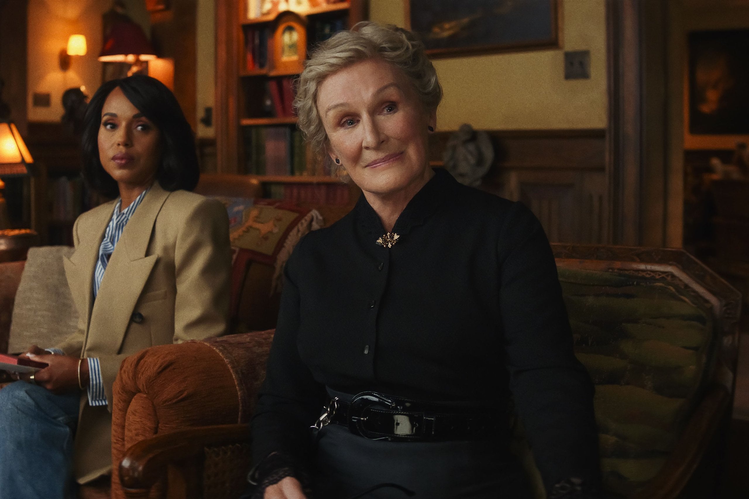 Actors Glenn Close and Kerry Washington sit on a couch in a still from "Wake Up Dead Man: A Knives Out Mystery."