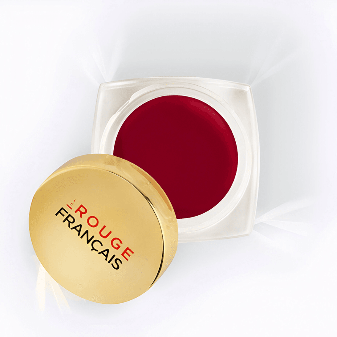An open pot of Le Rouge Français Tinted Balm in Sigrid, a deep cherry color