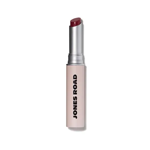 A tube of Jones Road lipstick in a dusty pink color against a white background