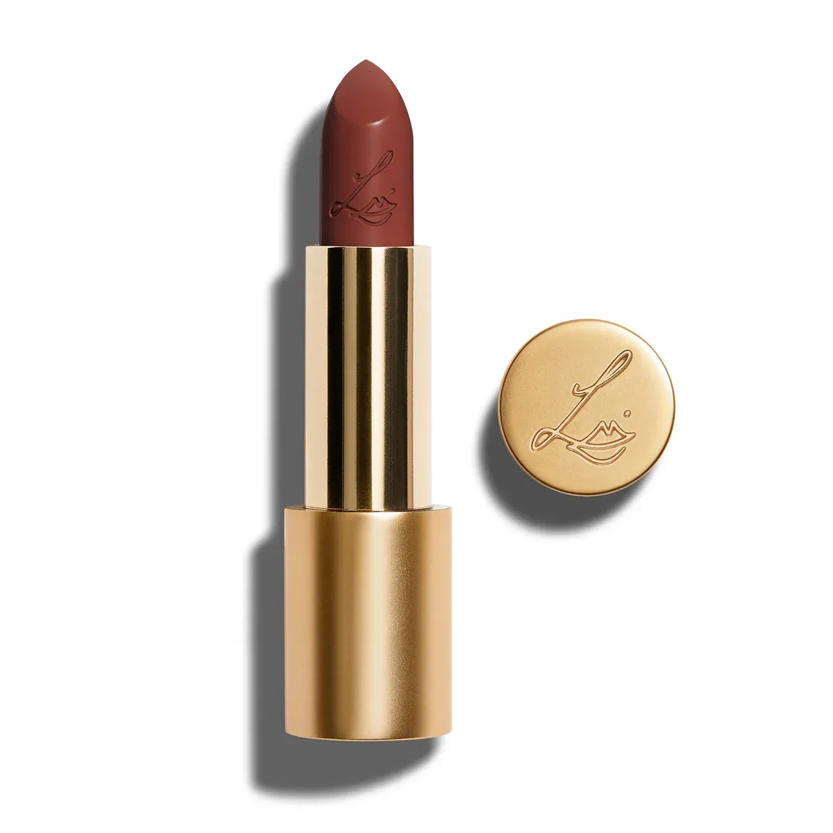 A gold tube of mauve-brown lipstick on a white background