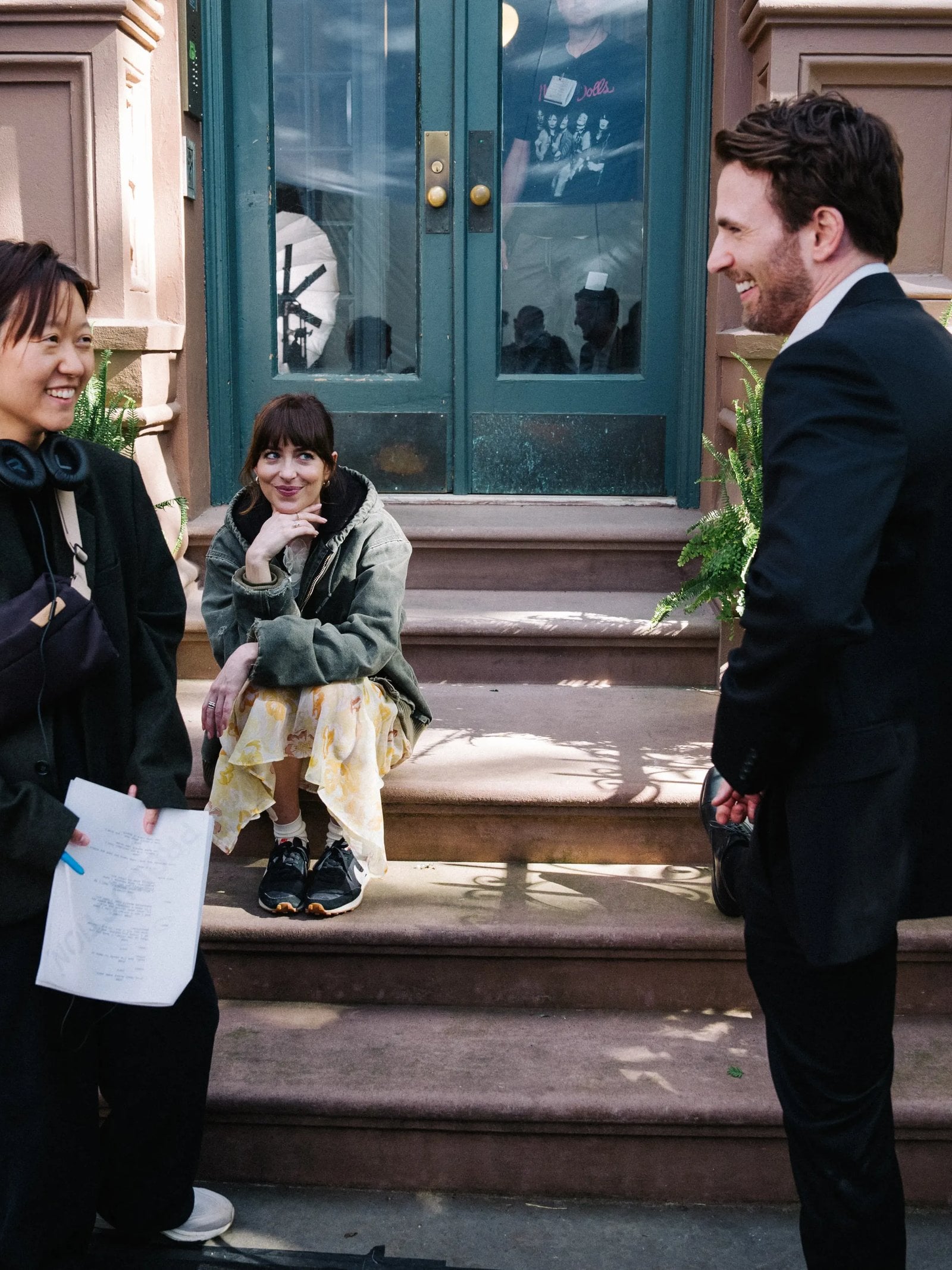 (L - R) Celine Song, Dakota Johnson, and Chris Evans on the set of "Materialists"