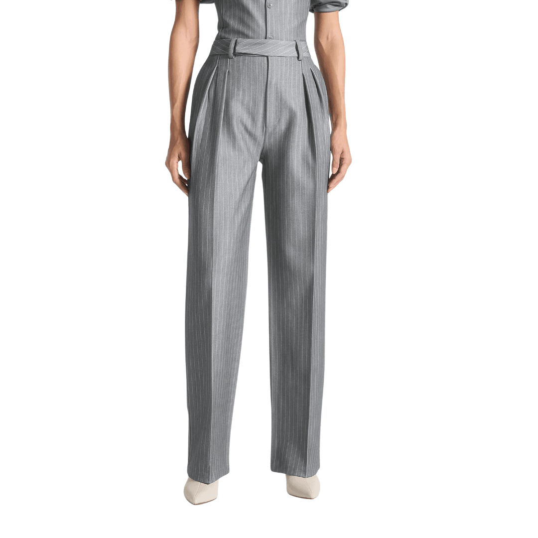 the bottom half of a model wearing Manière De Voir pinstripe pleat tailored trousers in a pale gray color