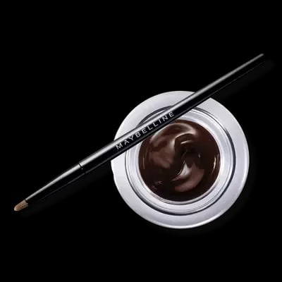 A pot of Maybelline cream eyeliner in a brown shade, with the brush laying on top of it
