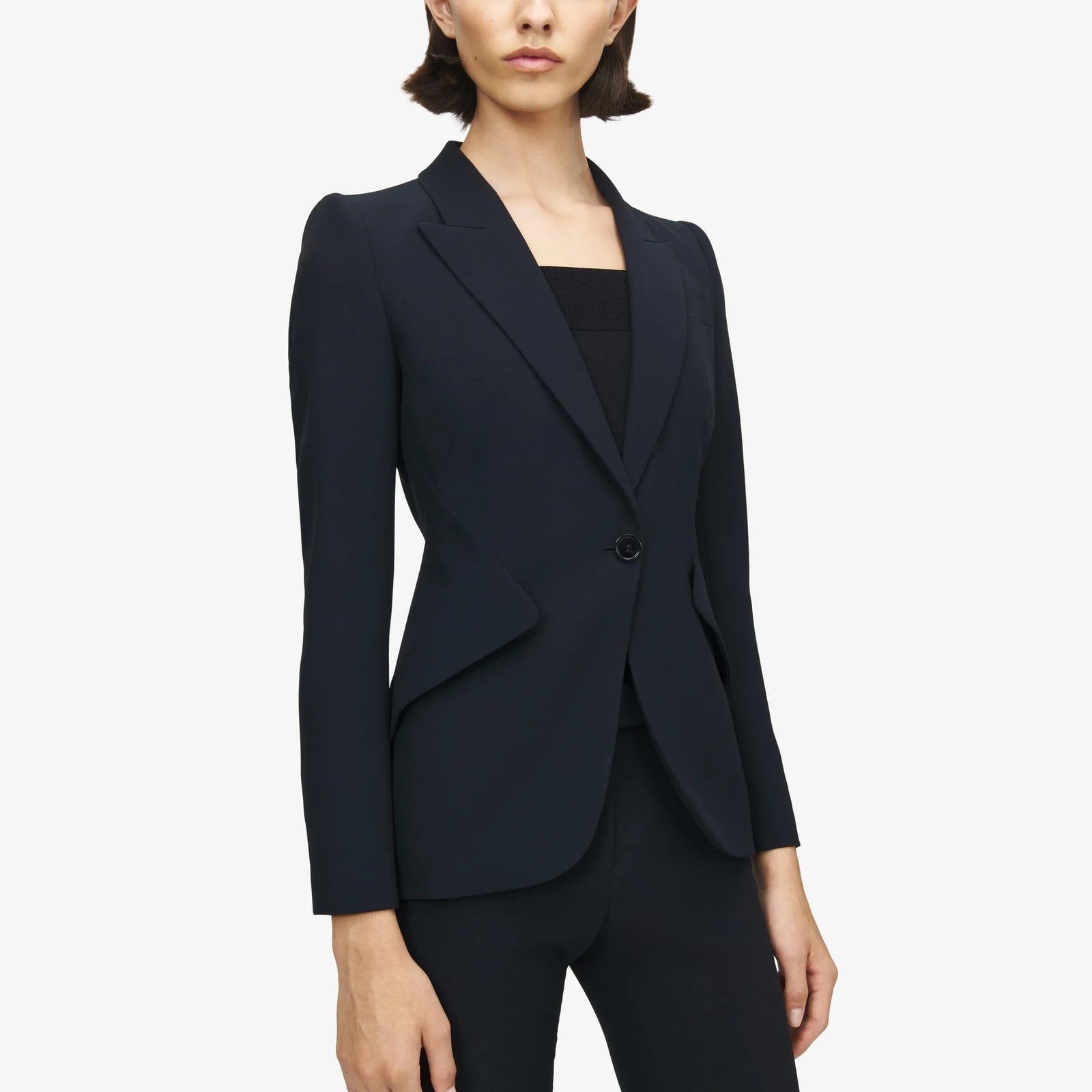 A model wears the McQueen Peak Shoulder Leaf Crepe Jacket in black