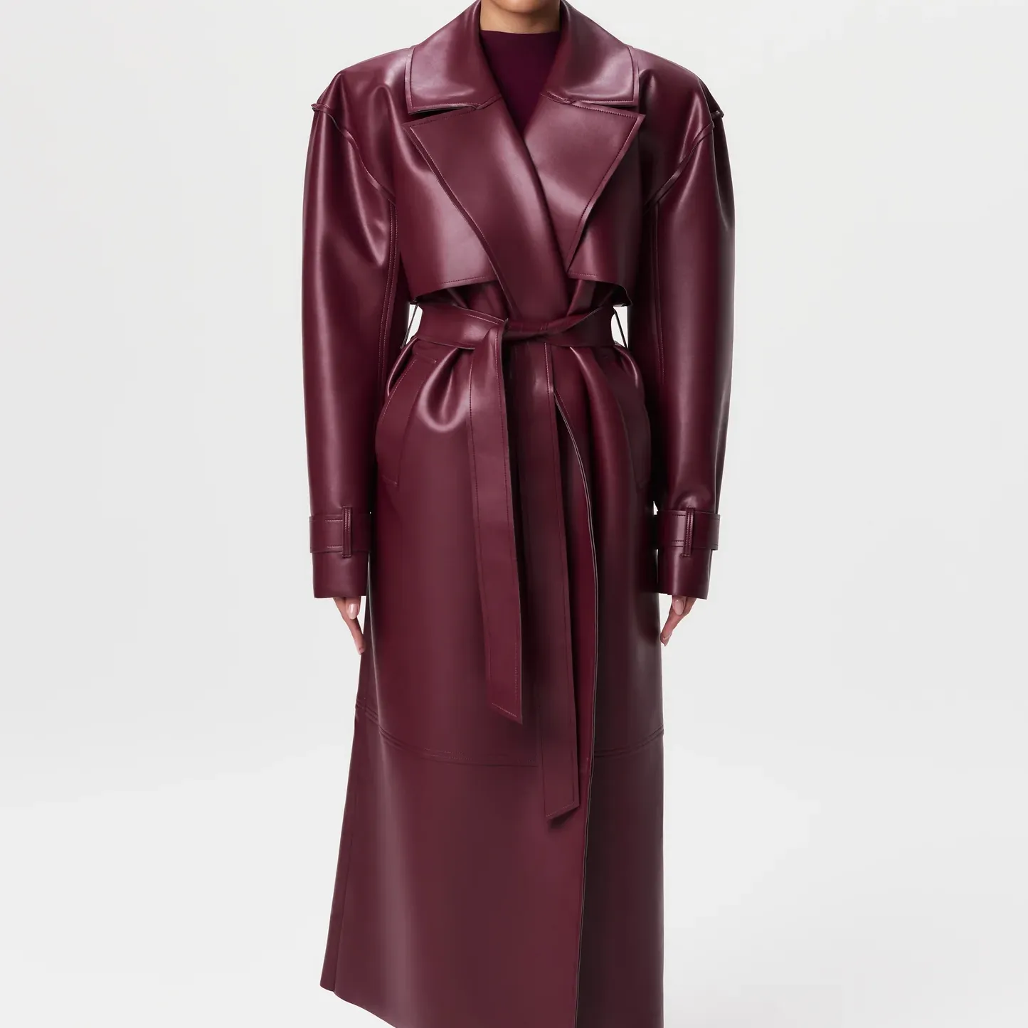 A model wear a burgundy faux leather trench coat from Naked Wardrobe.