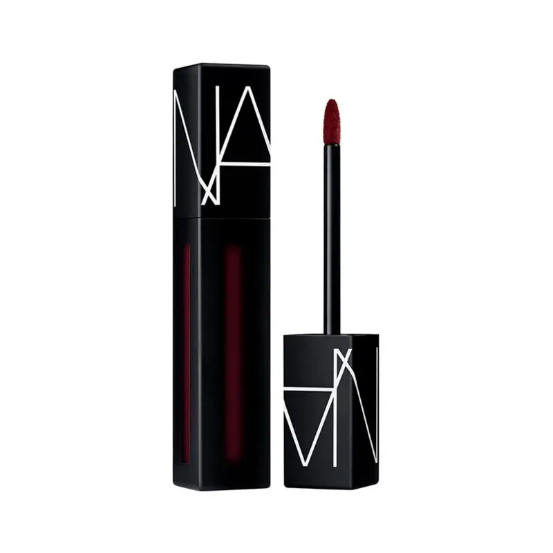 An open tube of the Nars Powermatte Lip Pigment in a deep berry shade against a white background.