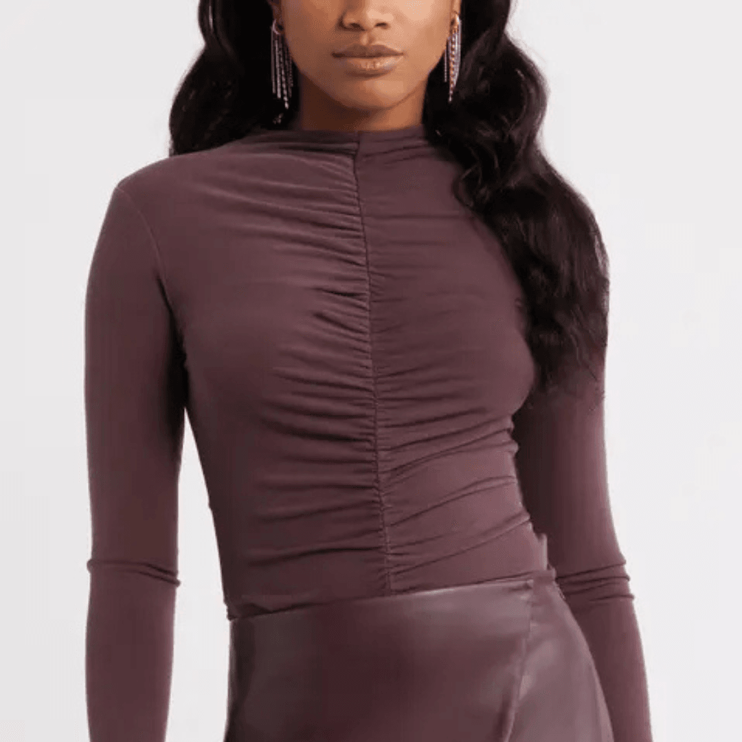 The top half of a model wearing the Open Edit Shirred Mock Neck Top in a plum color
