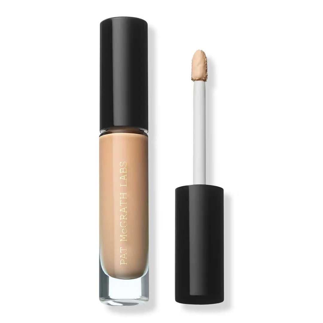A beige tube of concealer on light gray background