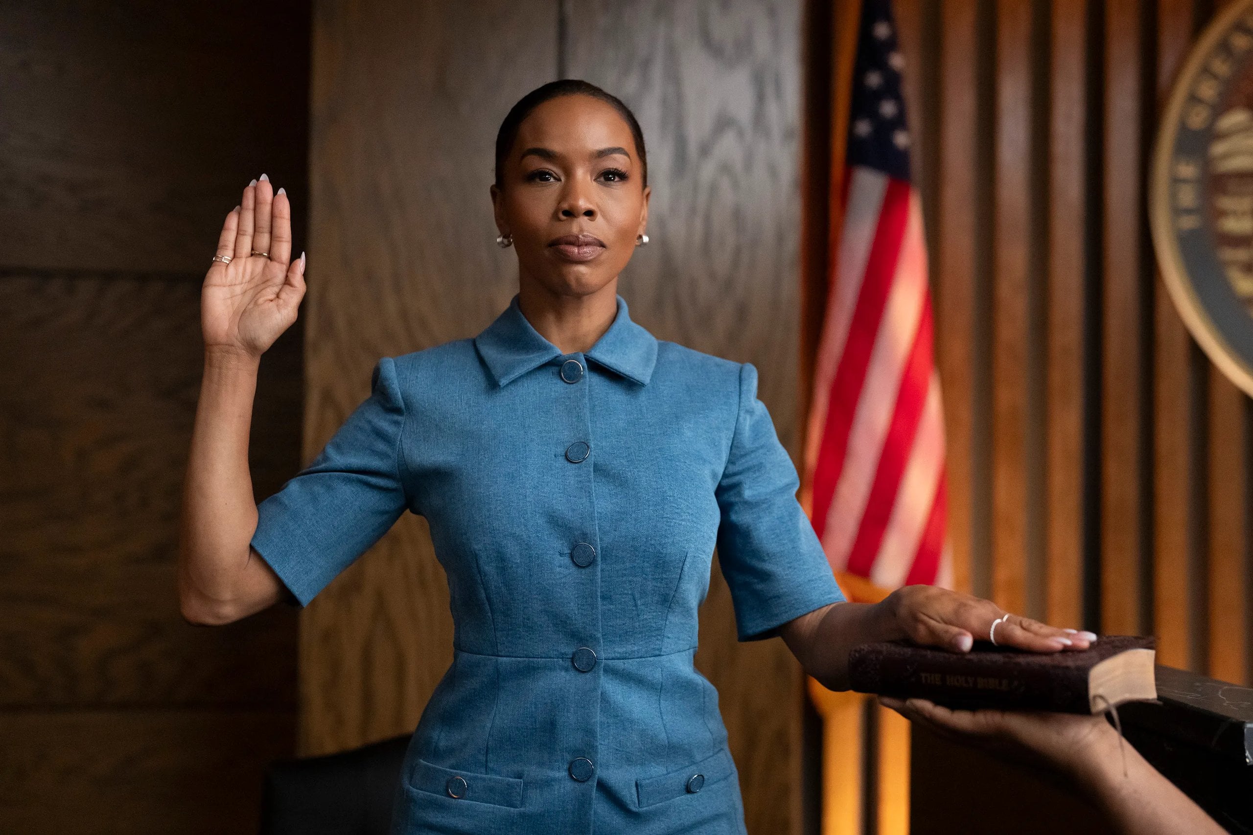 Actress Brandee Evans takes the witness stand and raises her right hand in a scene from Reasonable Doubt.