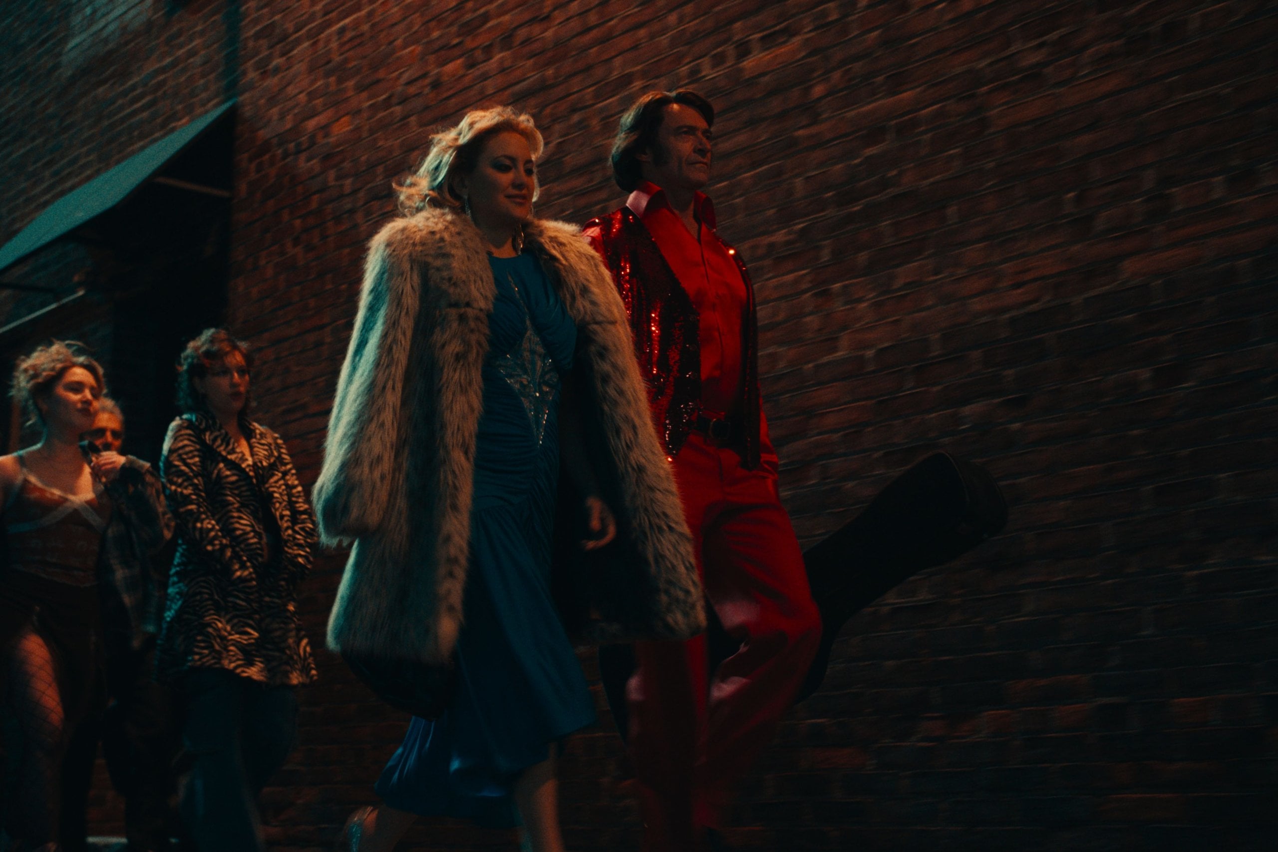 The cast of Song Sung Blue walks into the theater for Thunder & Lightning to open for Pearl Jam in a still from Song Sung Blue.