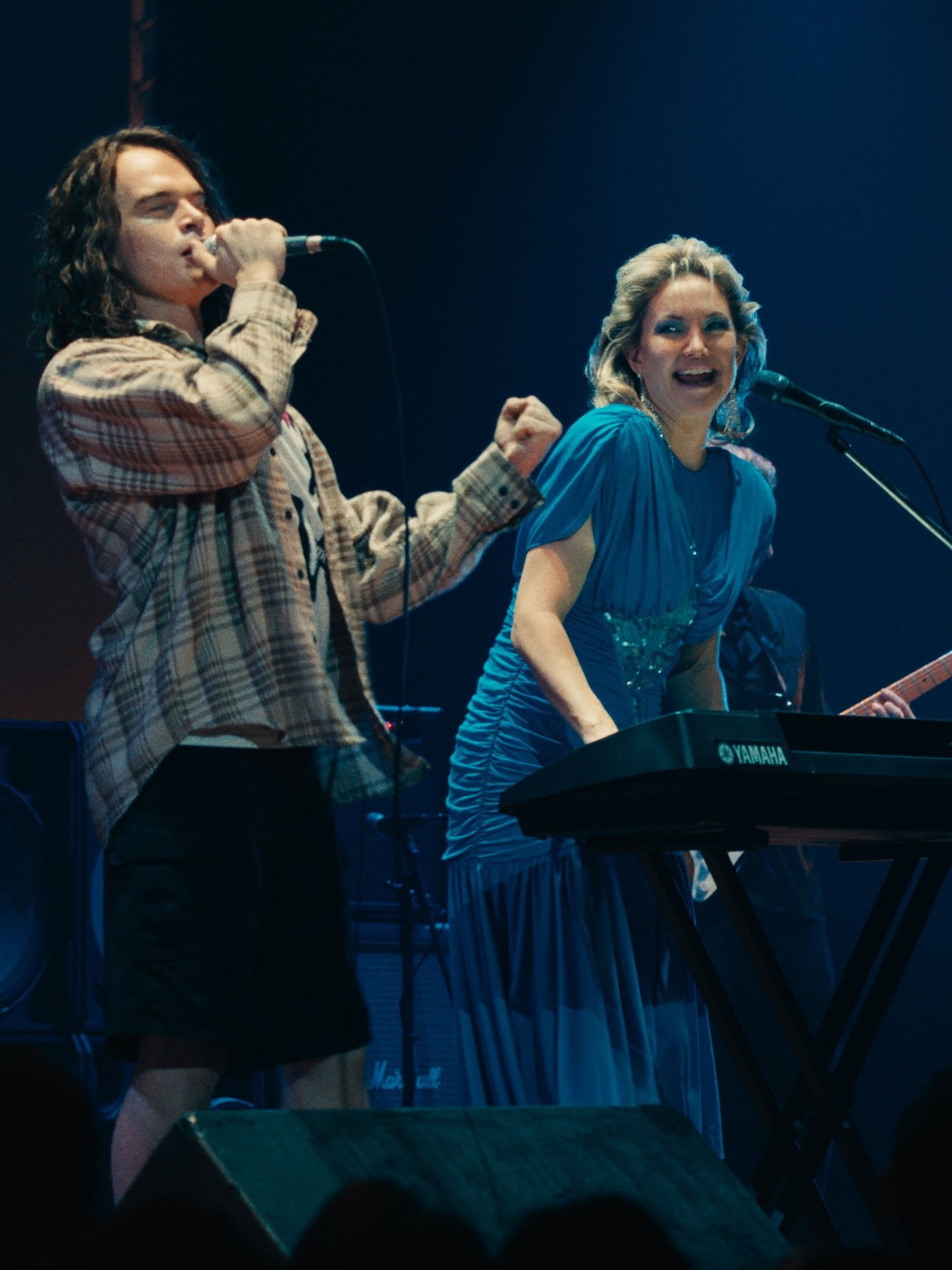 Actor John Beckwith as Eddie Vedder, plays on stage with Kate Hudson and Hugh Jackman in a still from Song Sung Blue.