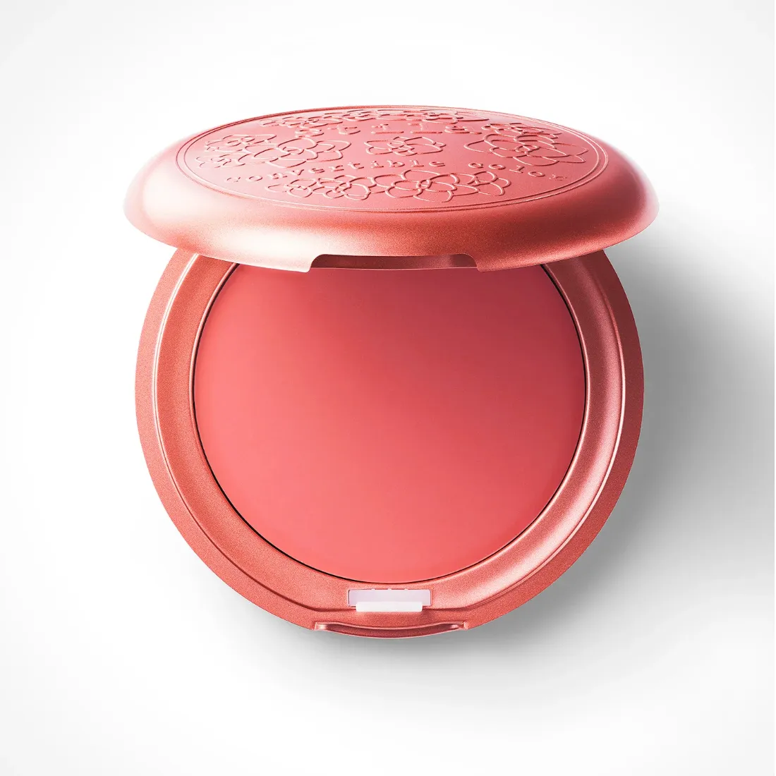 An open compact of Stila Convertible Color in a peachy-pink color against a white background