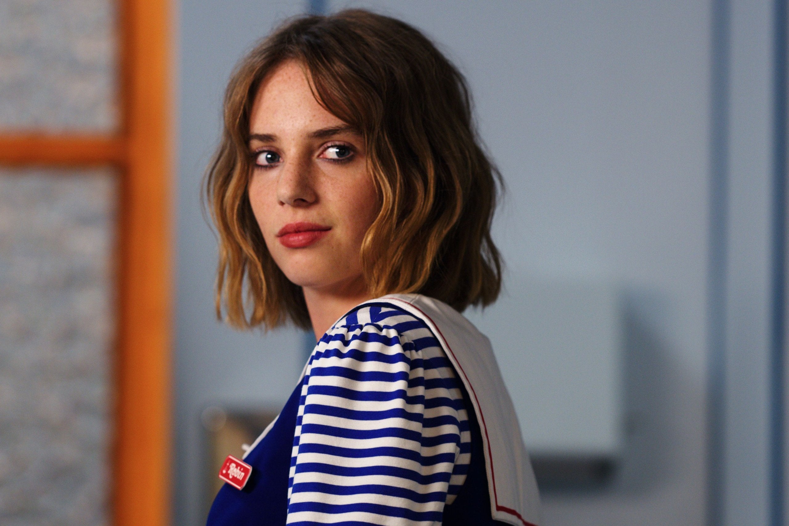 Actress Maya Hawke in a sailor's uniform, looking at the camera, in a still from "Stranger Things."