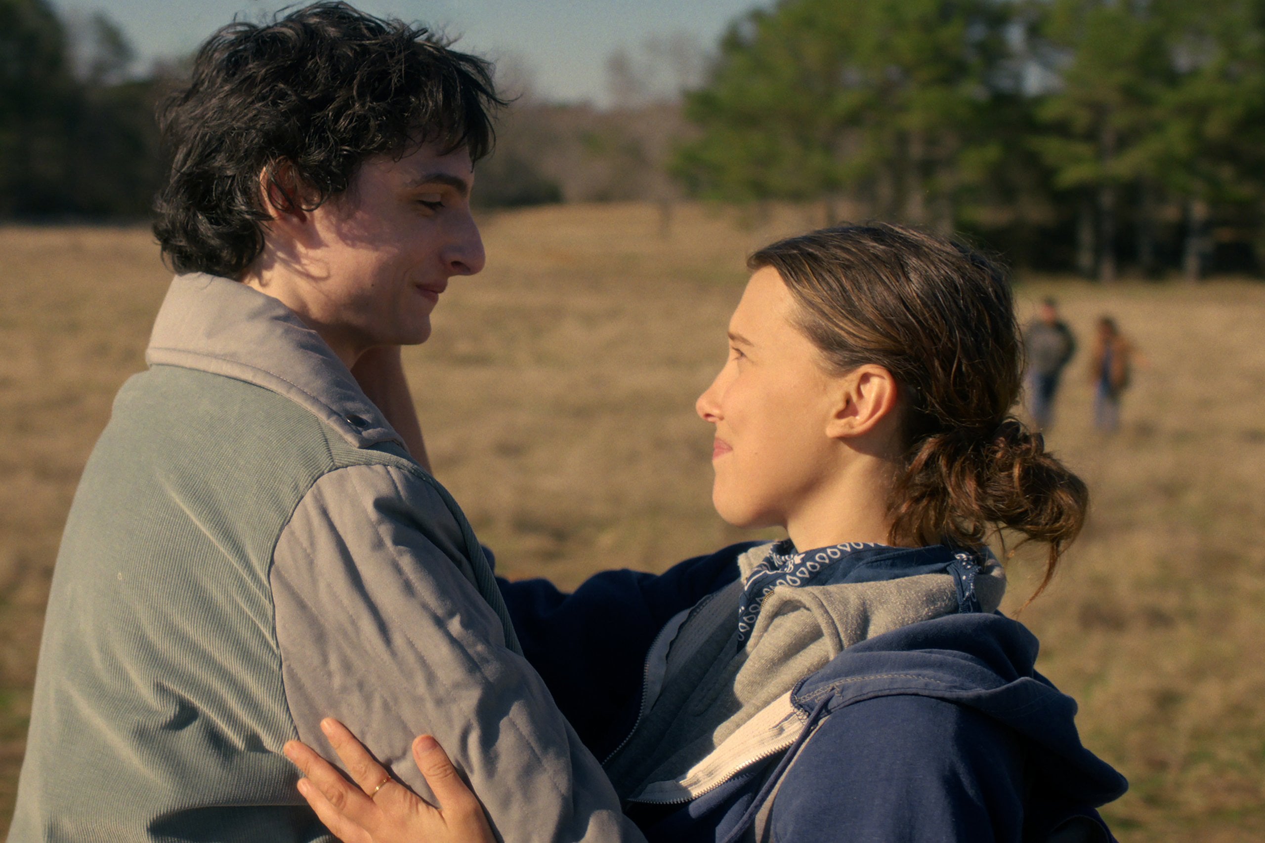 Actors Finn Wolfhard and Millie Bobbi Brown embrace in a still from Stranger Things season five.