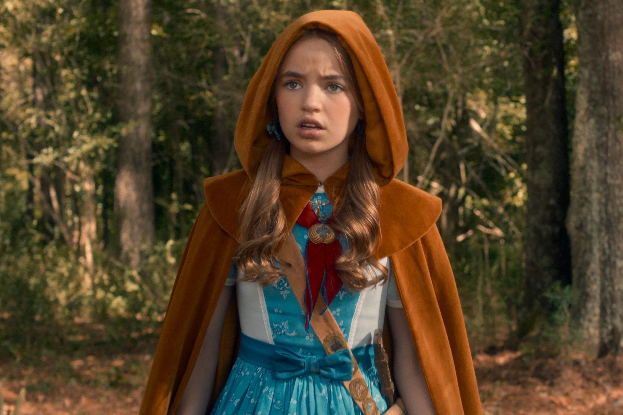 Actor Nell Fisher wears a velvet cape and pigtails as Holly Wheeler in "Stranger Things" season five.